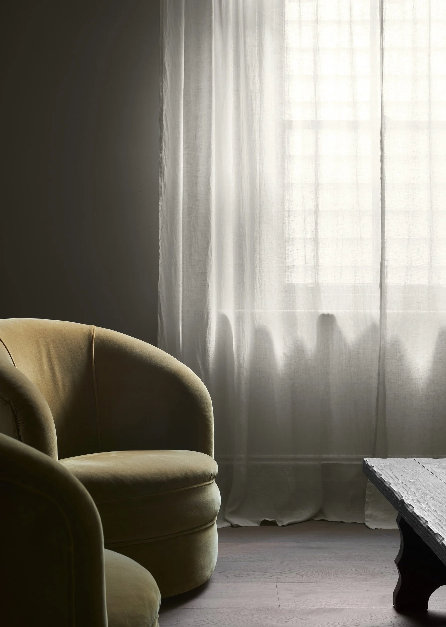 Richmond House olive armchairs beside a sheer-curtained window