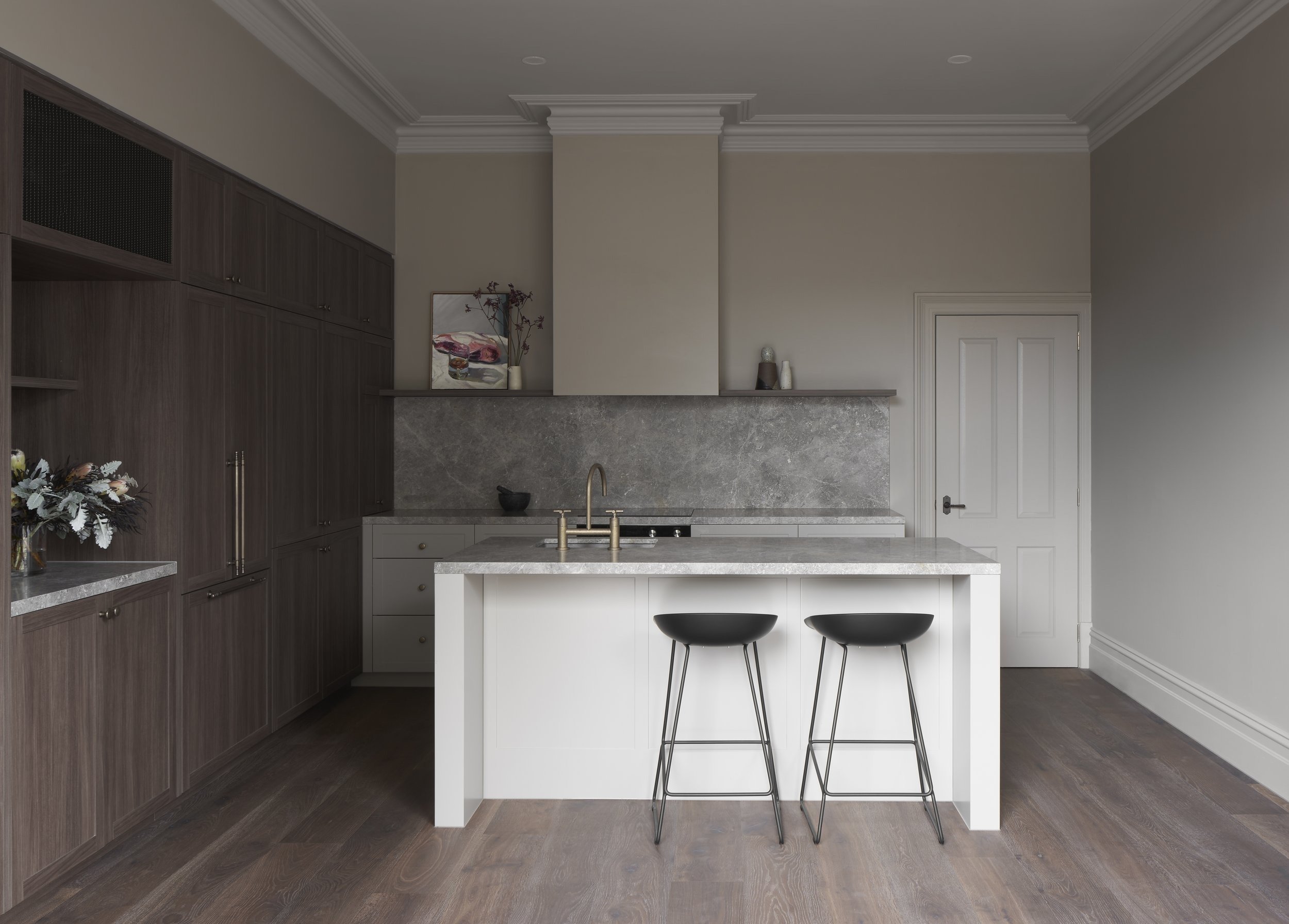 Richmond House kitchen with white island, black stools and timber cabinetry