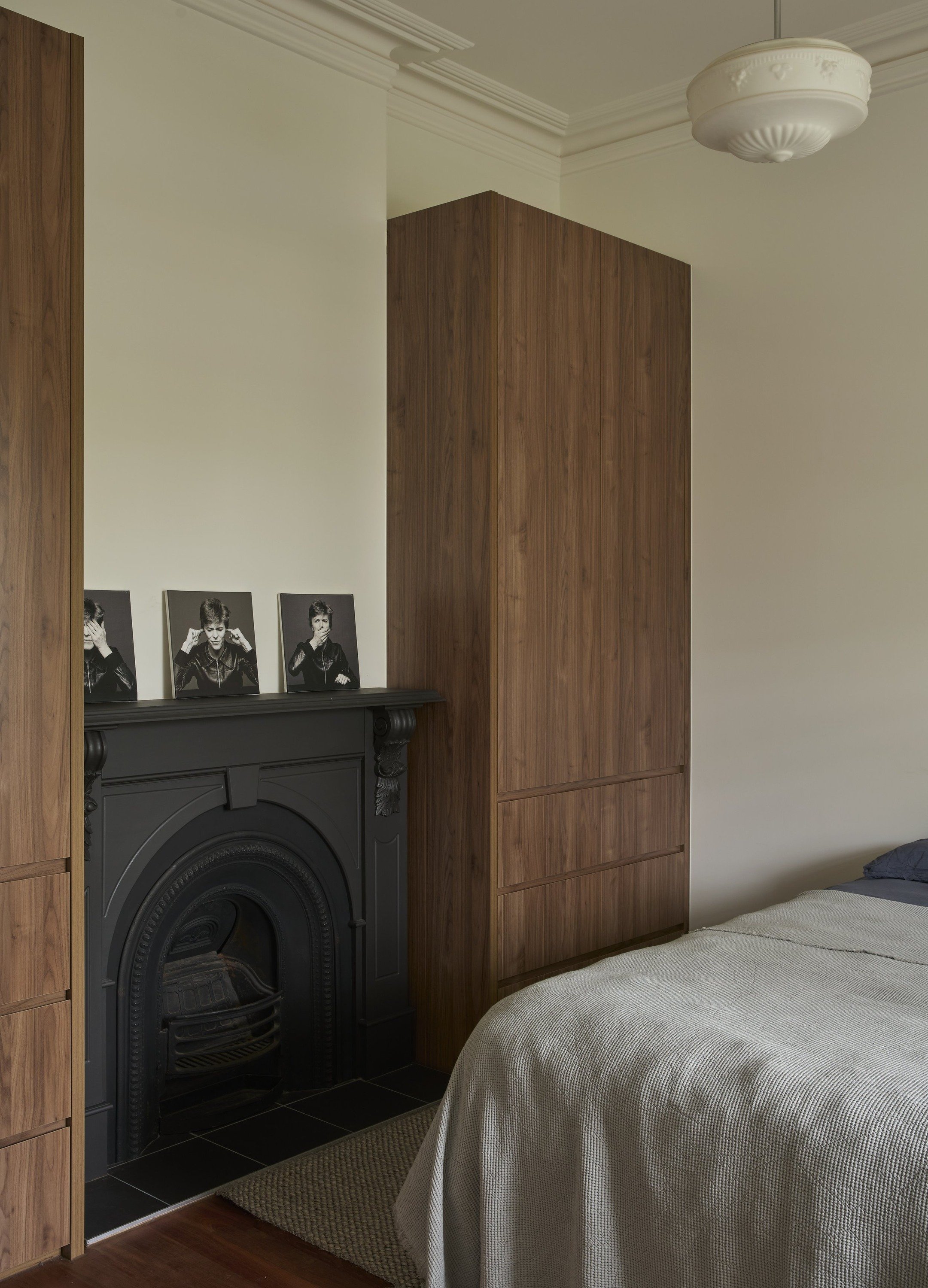 Carlton North House bedroom with black period fireplace and timber wardrobe