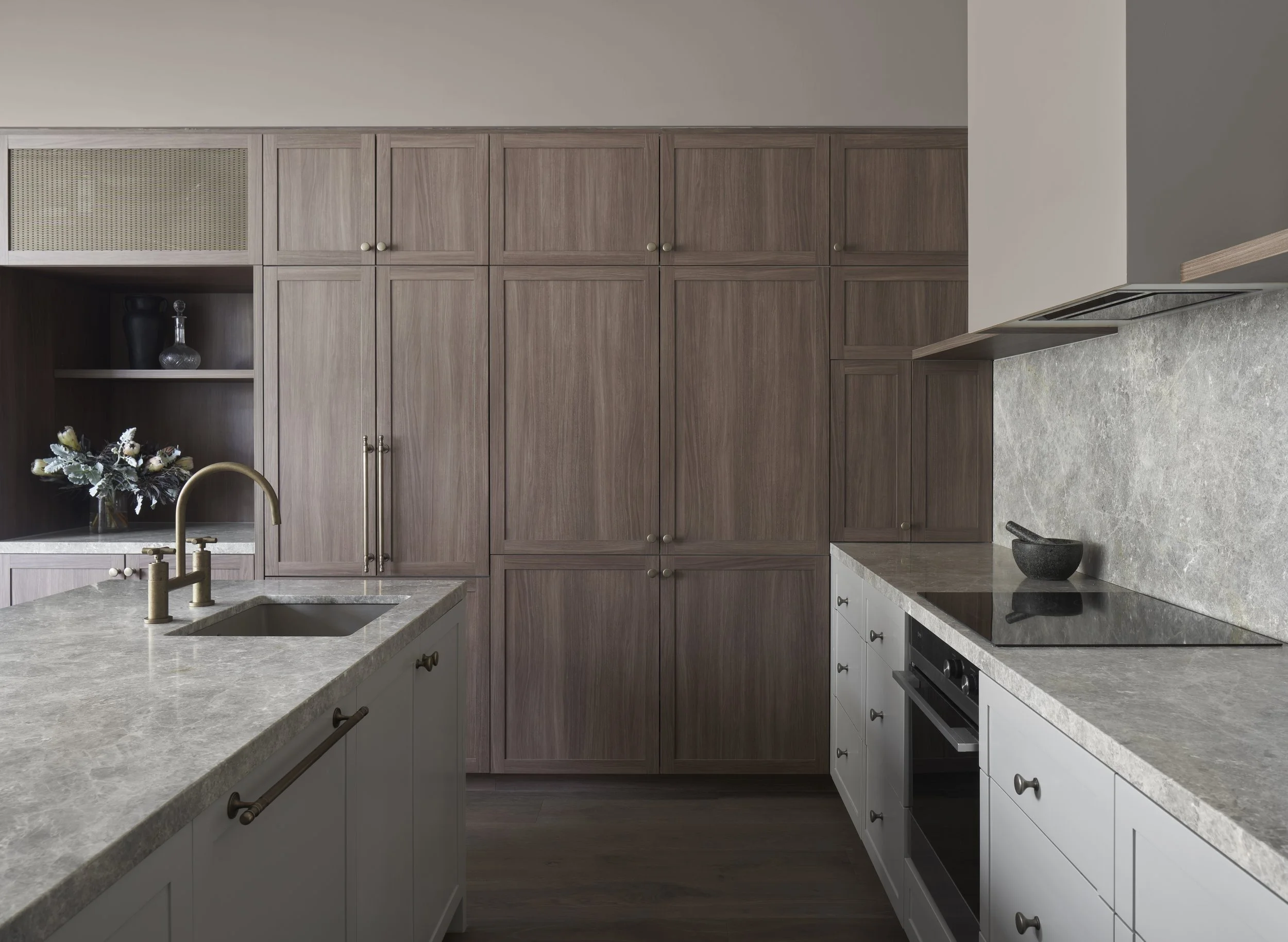Richmond House kitchen with stone benchtops, timber cabinetry and rangehood