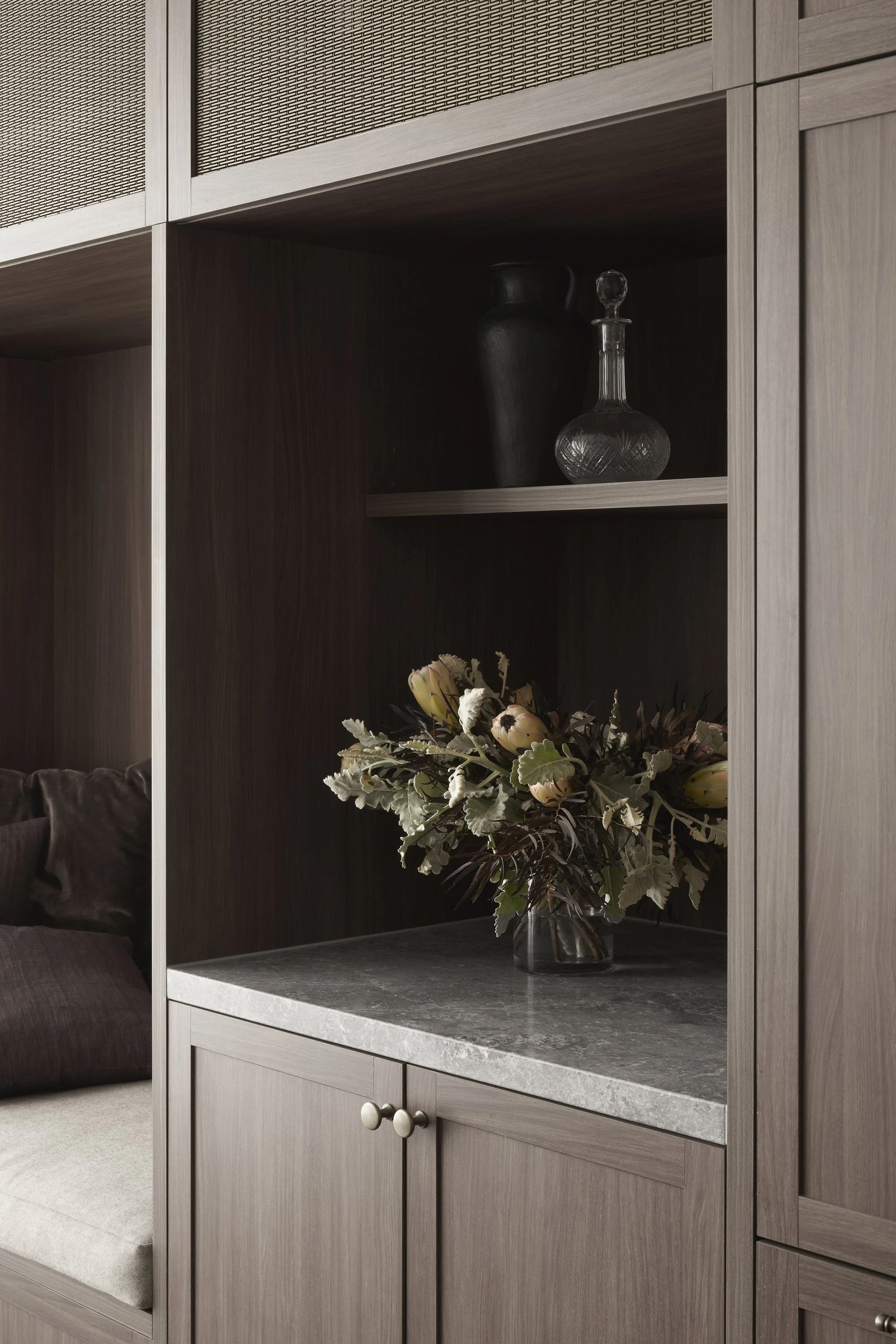 Richmond House dark timber joinery with display shelves, stone top and native flowers