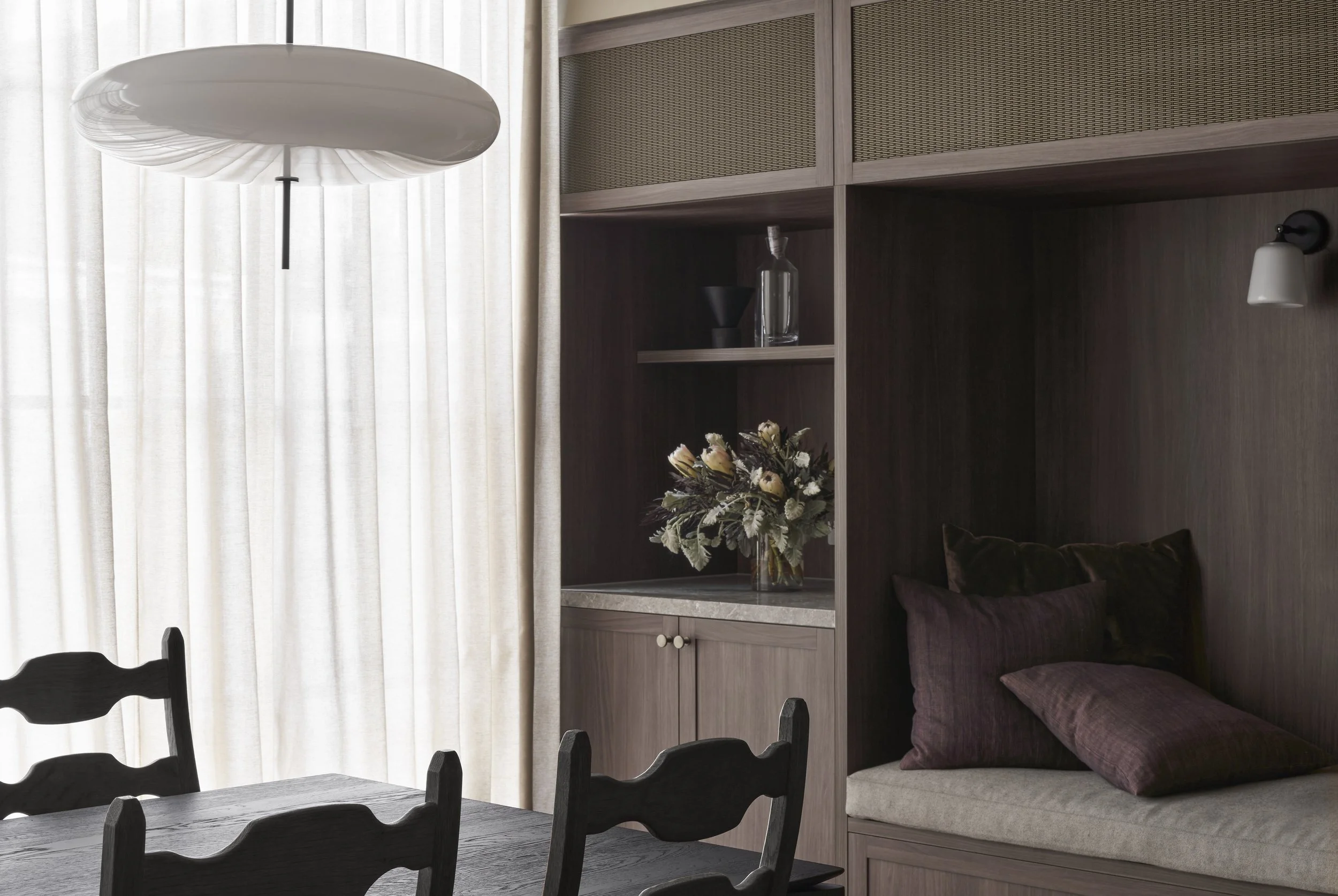Richmond House dining area beside timber joinery with built-in bench seat