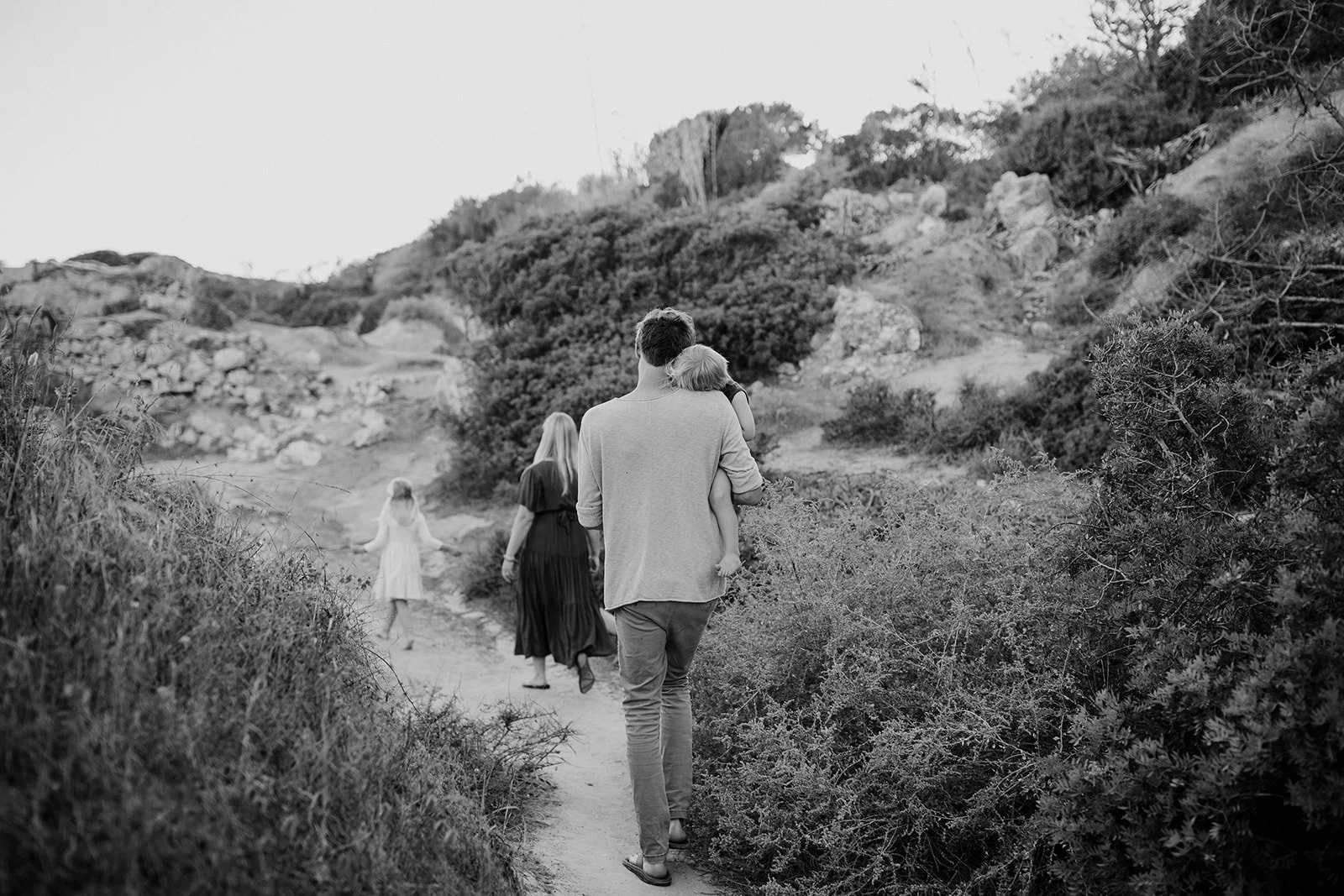 A heartwarming image of a family walking along the seaside, capturing the essence of togetherness