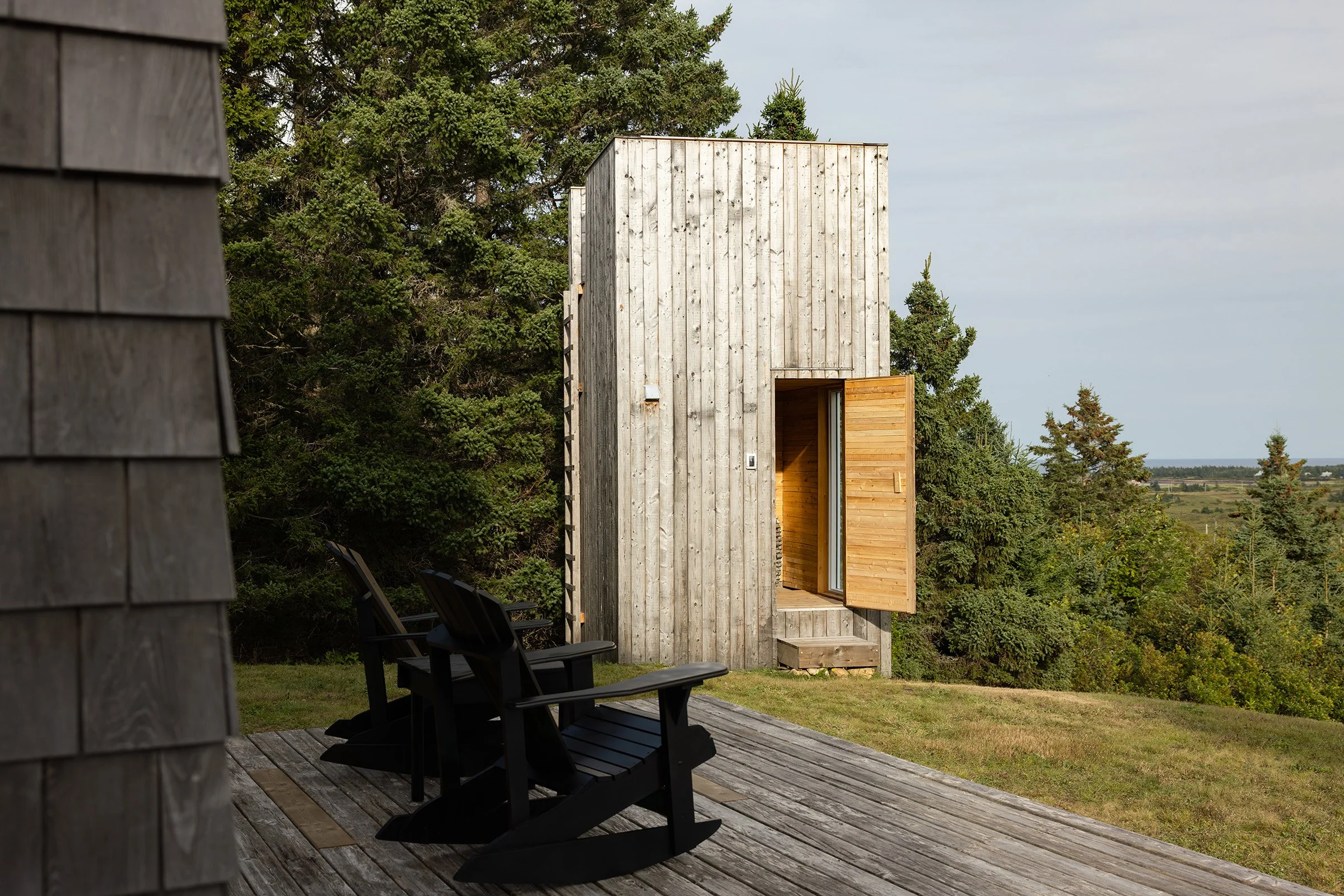 Open sauna door in Kingsburg, Nova Scotia revealing a warm wood interior