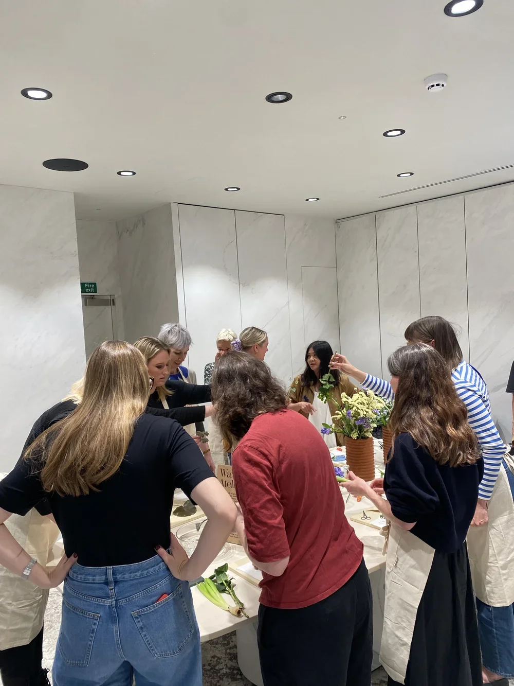Image of people at a wax flower workshop at Iris Ceramica