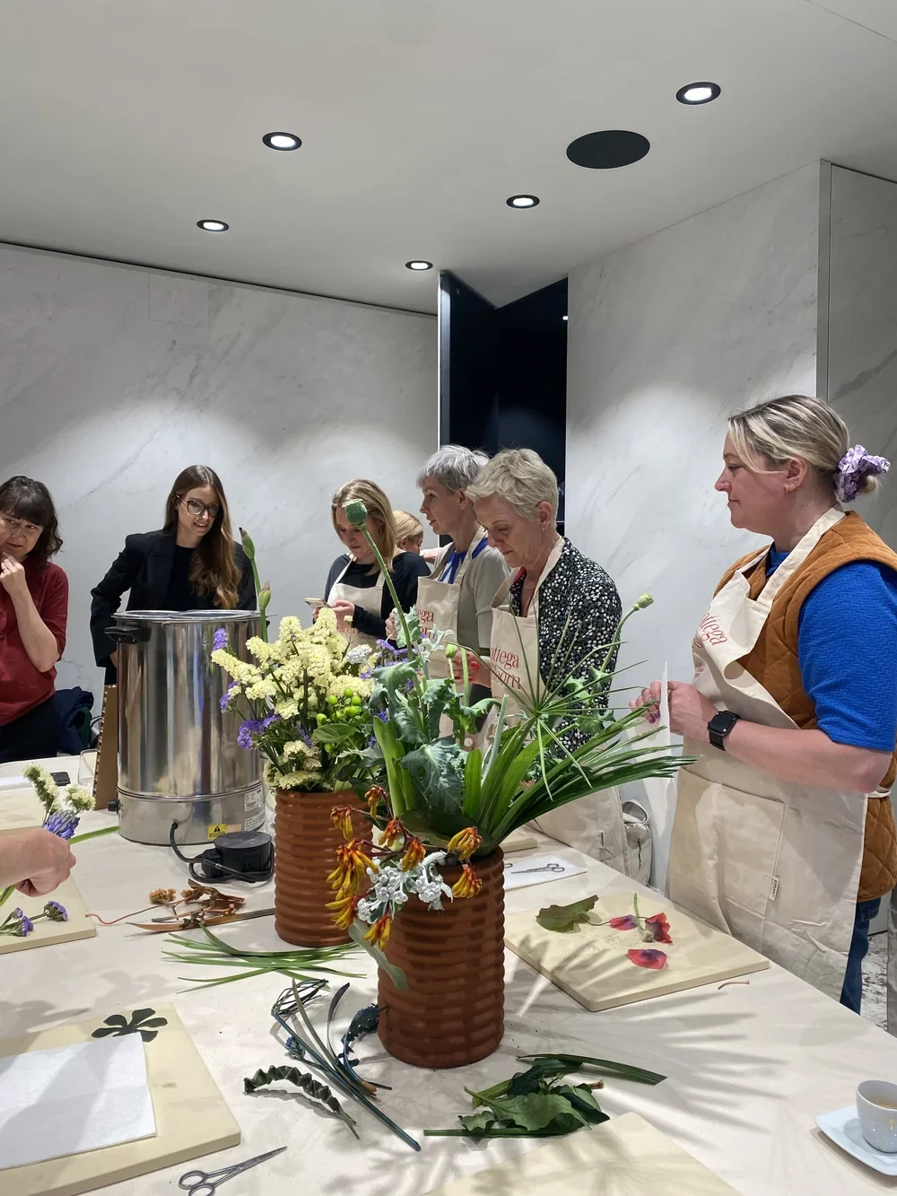 Image of people at a wax flower workshop at Iris Ceramica 2