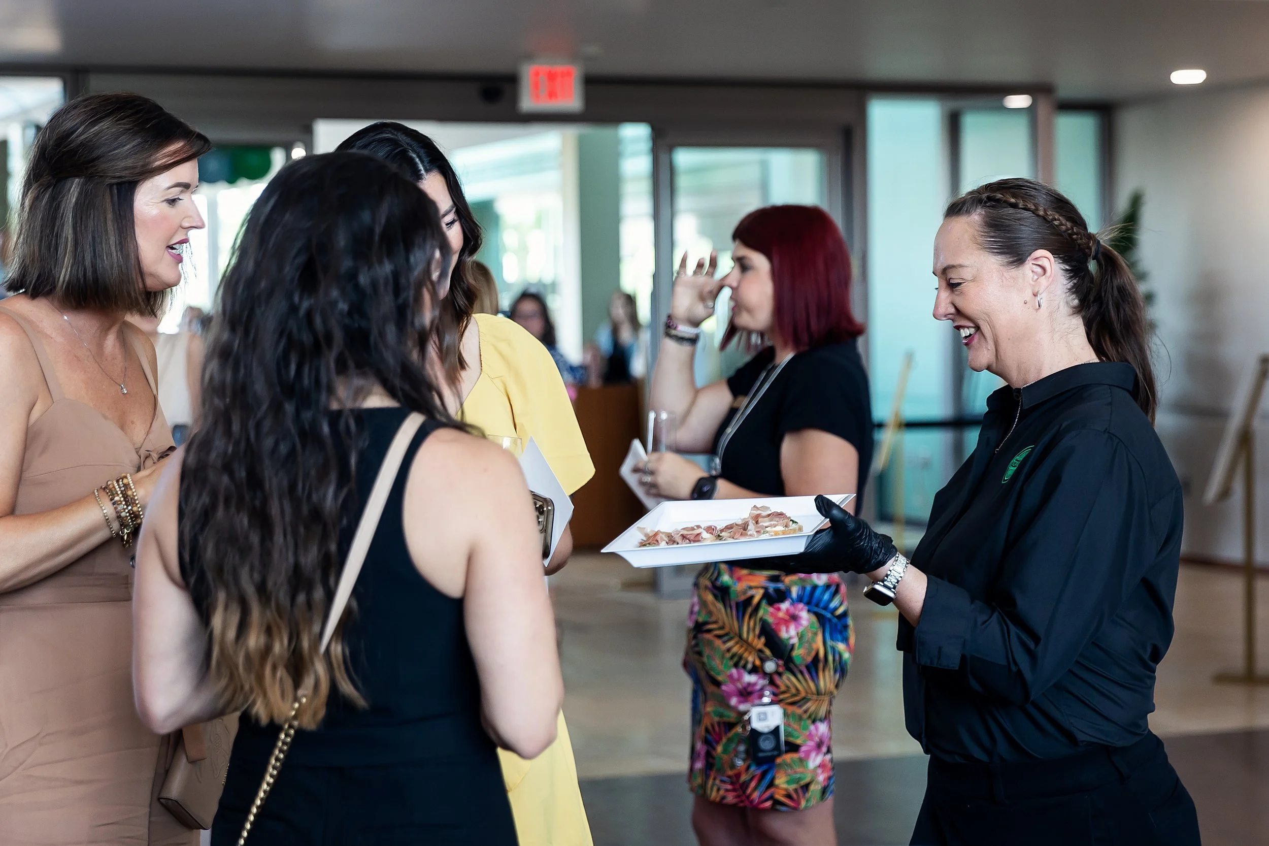 Top Shelf Cuisine & Cocktails team member serving appetizers and interacting with guests at an Oklahoma City event.