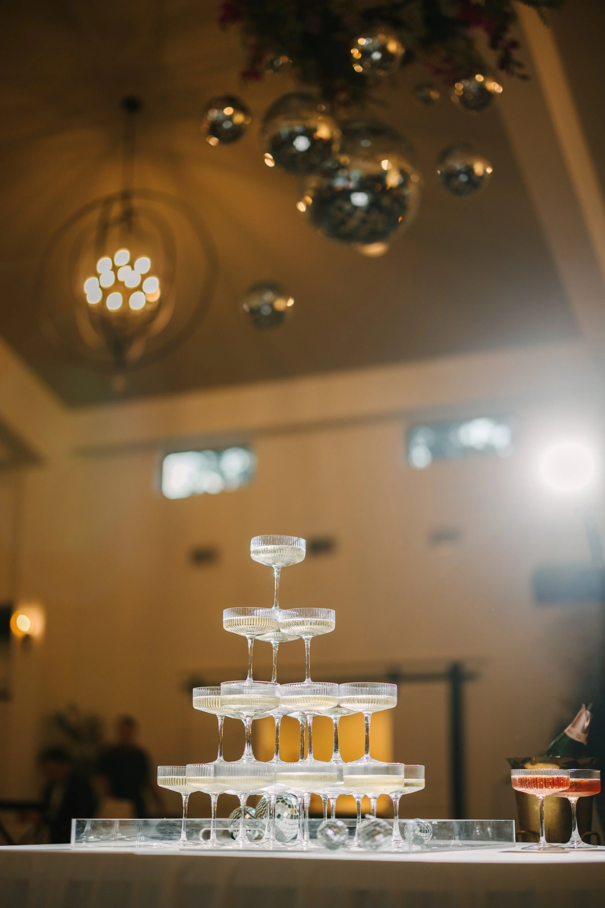 Champagne tower at a luxury Oklahoma City wedding reception, showcasing elevated bartending service as part of a seamless catering and bar experience.