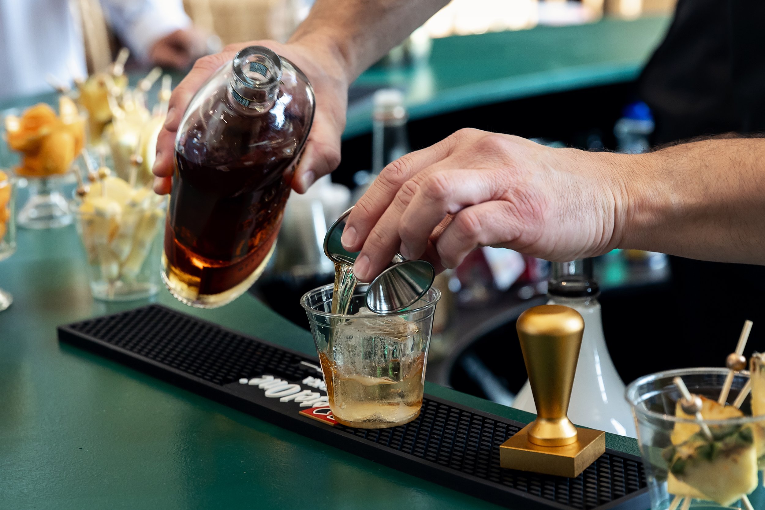Bartender crafting a signature cocktail for guests at an Oklahoma City event