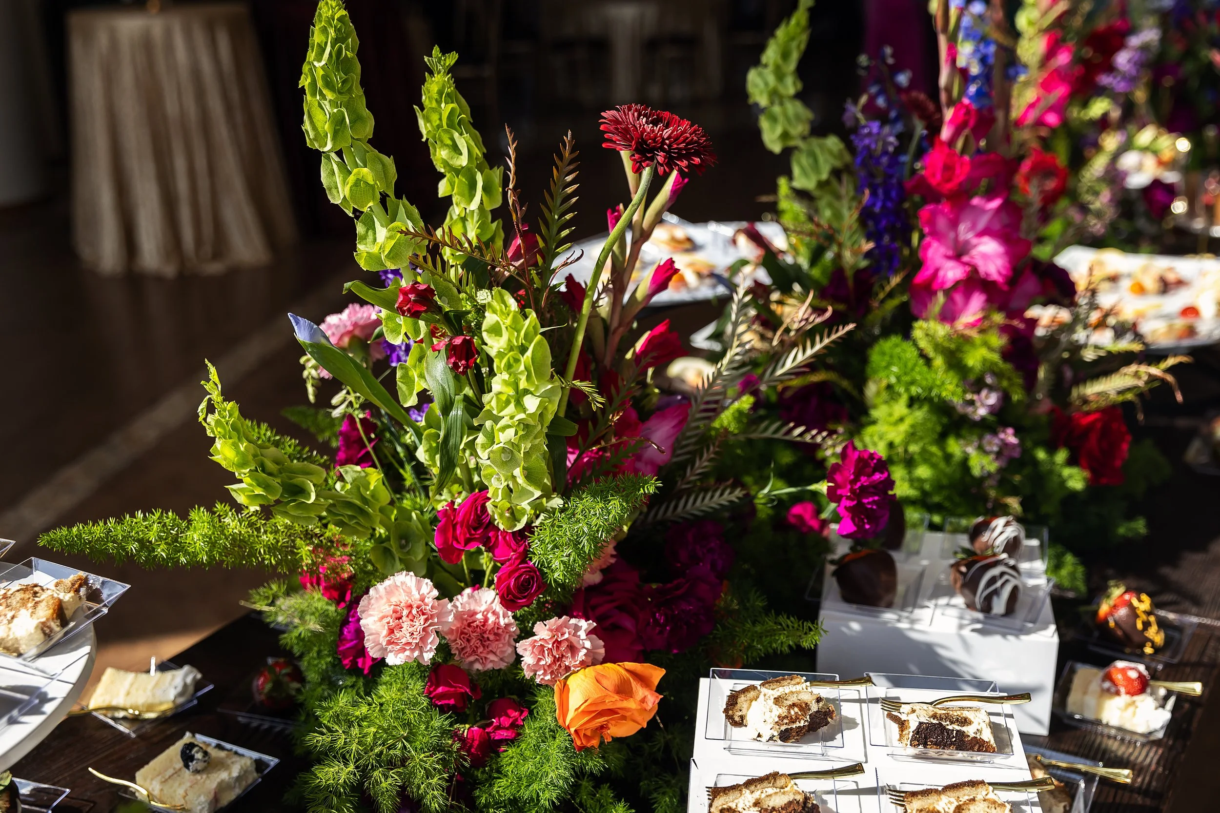 Luxury event catering setup with bespoke floral centerpiece and artisanal desserts in Oklahoma City
