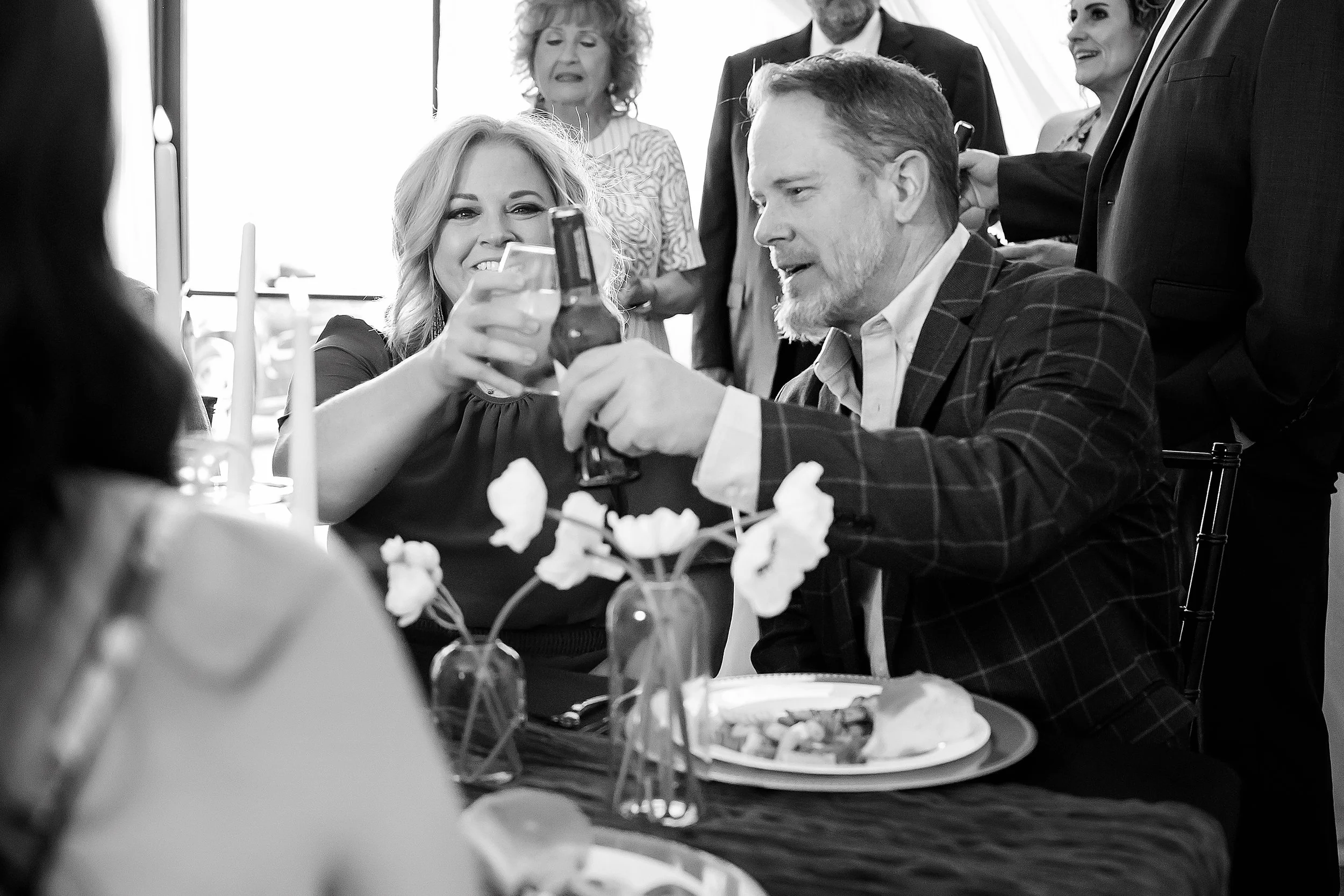 Guests enjoying a luxury Oklahoma City event with professional bartending services, raising cocktails and drinks during an elegant catered celebration.
