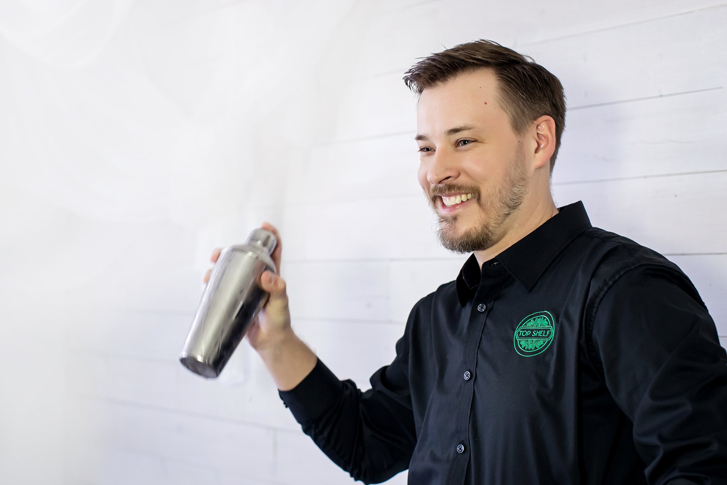 Professional bartender shaking a cocktail at an Oklahoma City retirement party catered by Top Shelf Cuisine & Cocktails