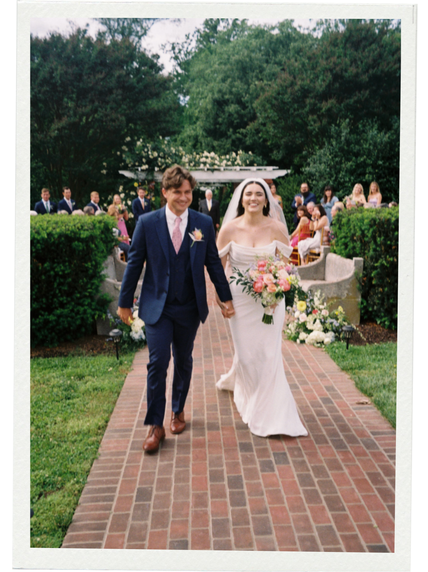 The bride and groom walking down the aisle. The image was captured on 35mm film at a wedding in Alexandria, Virginia.
