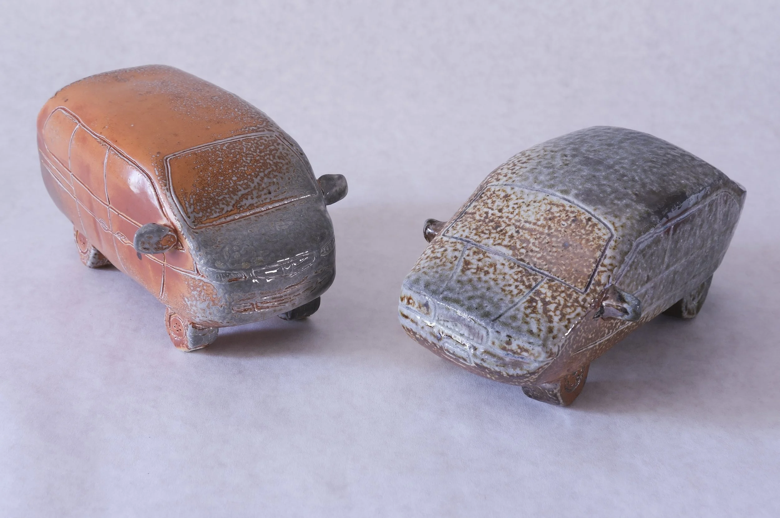Gift Objects (creatures), 2026, soda fired stoneware, 3.25" x 6" x 3.25" and 3" x 7" x 3.25"