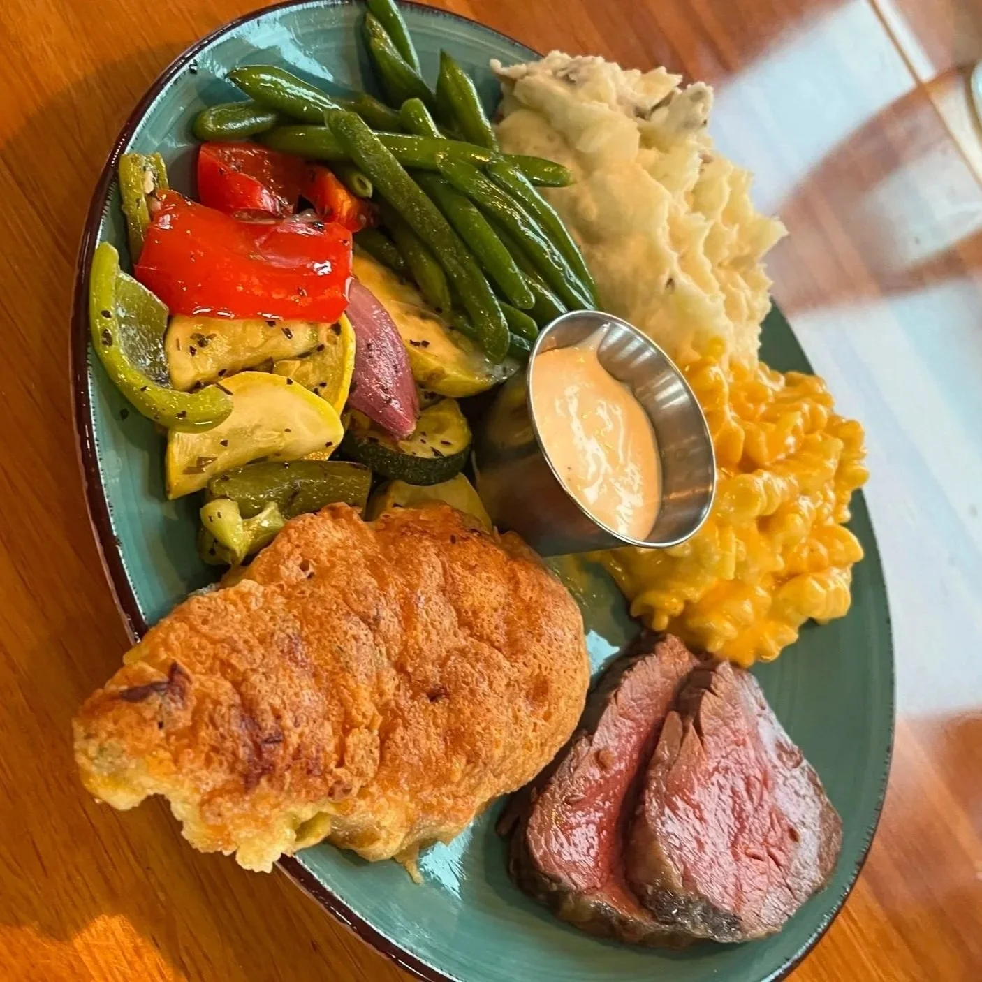 Parmesan Crusted Chicken and Slow Roasted Beef Tenderloin served with roasted Italian vegetables, green beans, skin-on mashed potatoes, and macaroni and cheese during a wedding catering tasting at Christopher's Restaurant & Catering in Dayton, Ohio.