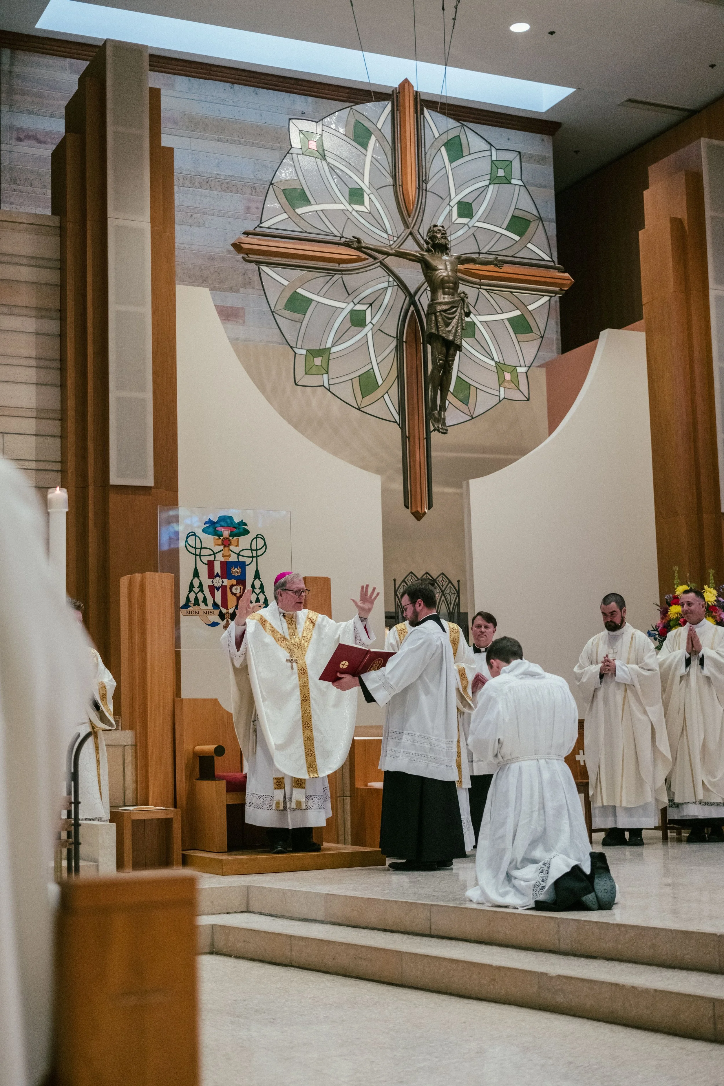 young-man-kneels-before-bishop