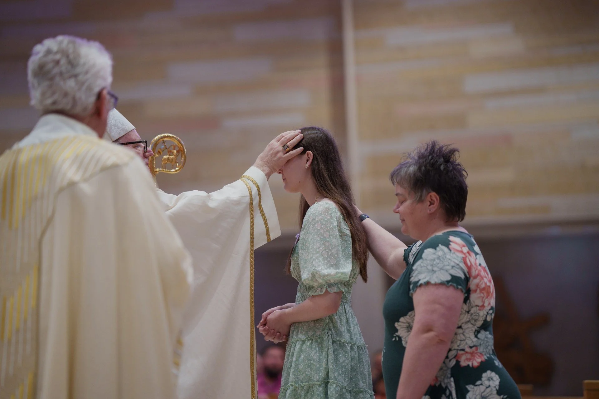 bishop performing confirmation ceremony in church