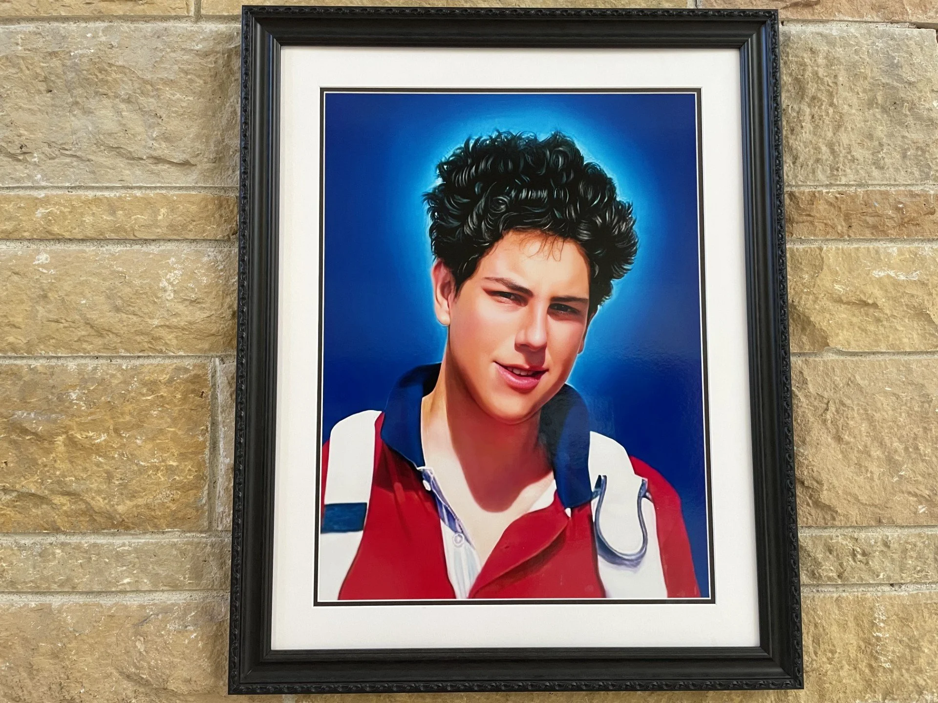 Image of St. Carlo Acutis on the wall at the Co-Cathedral