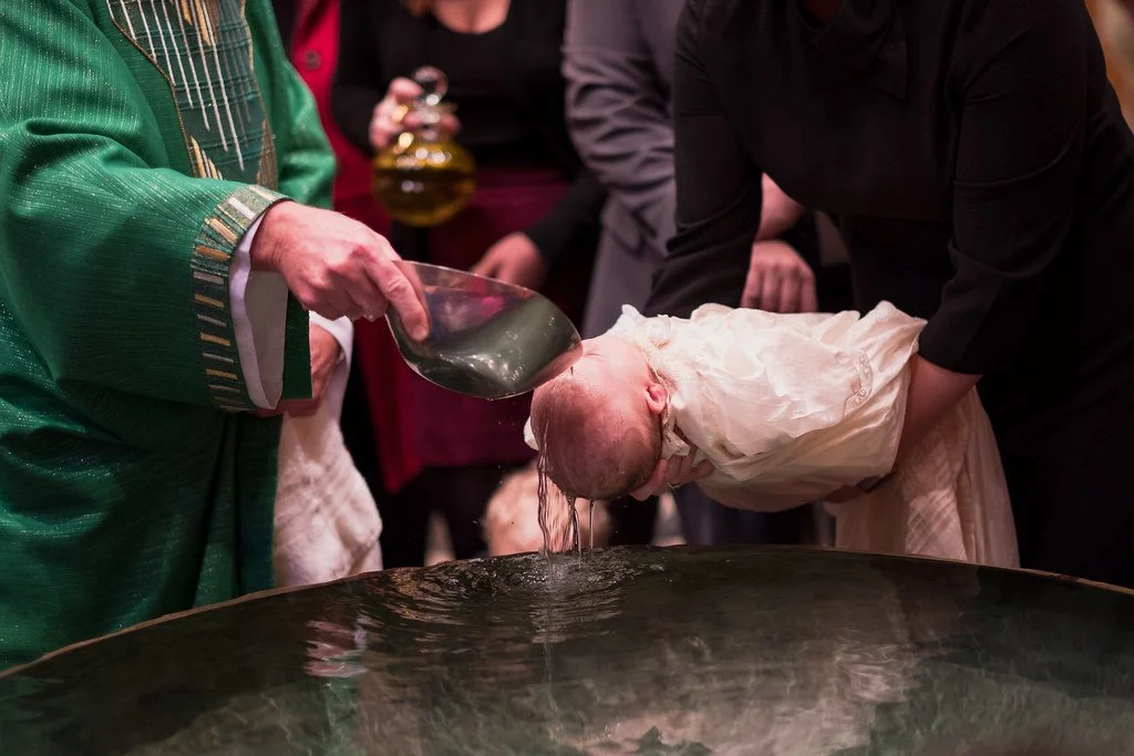 Baby being baptized at St. Johns