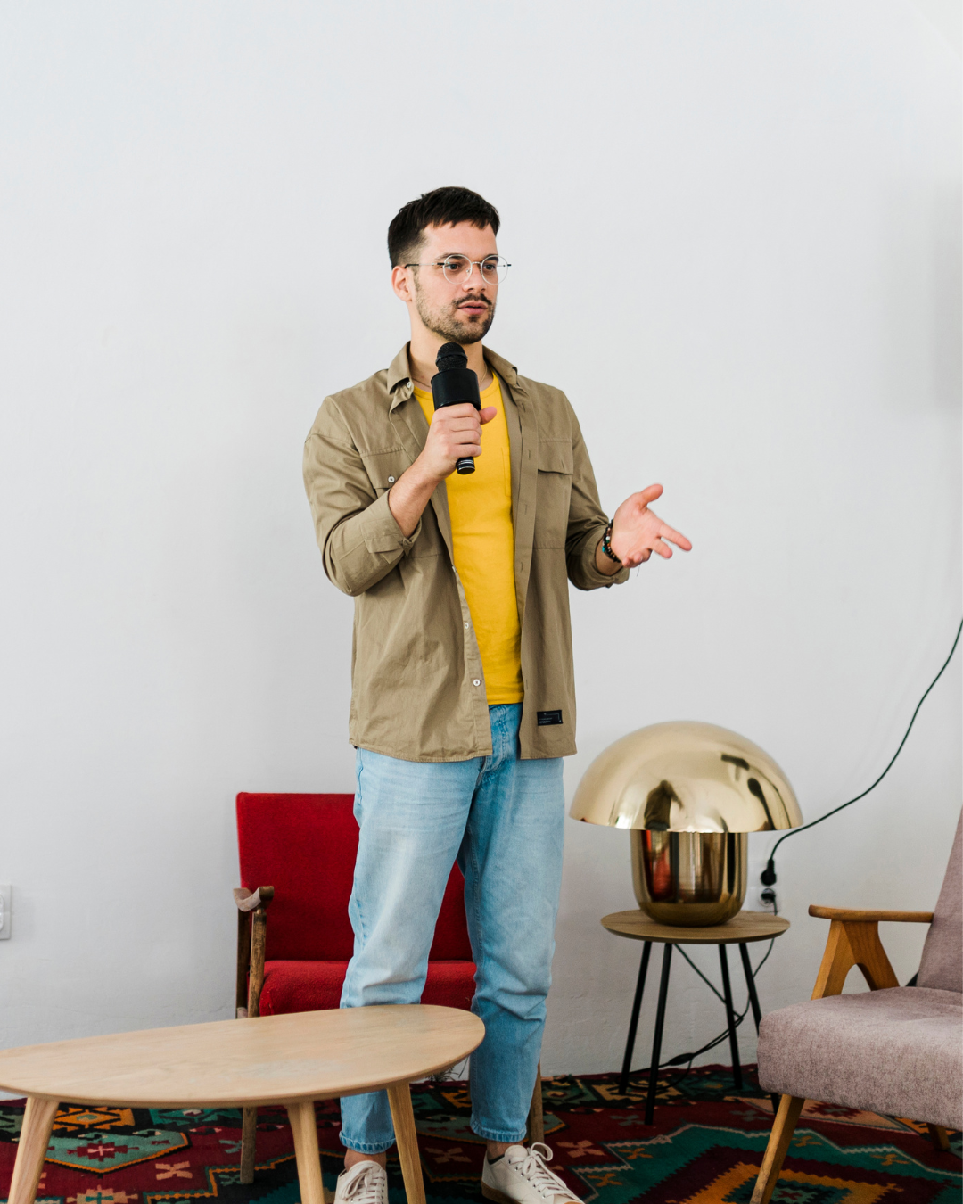 Male tech founder practicing investor pitch delivery with microphone