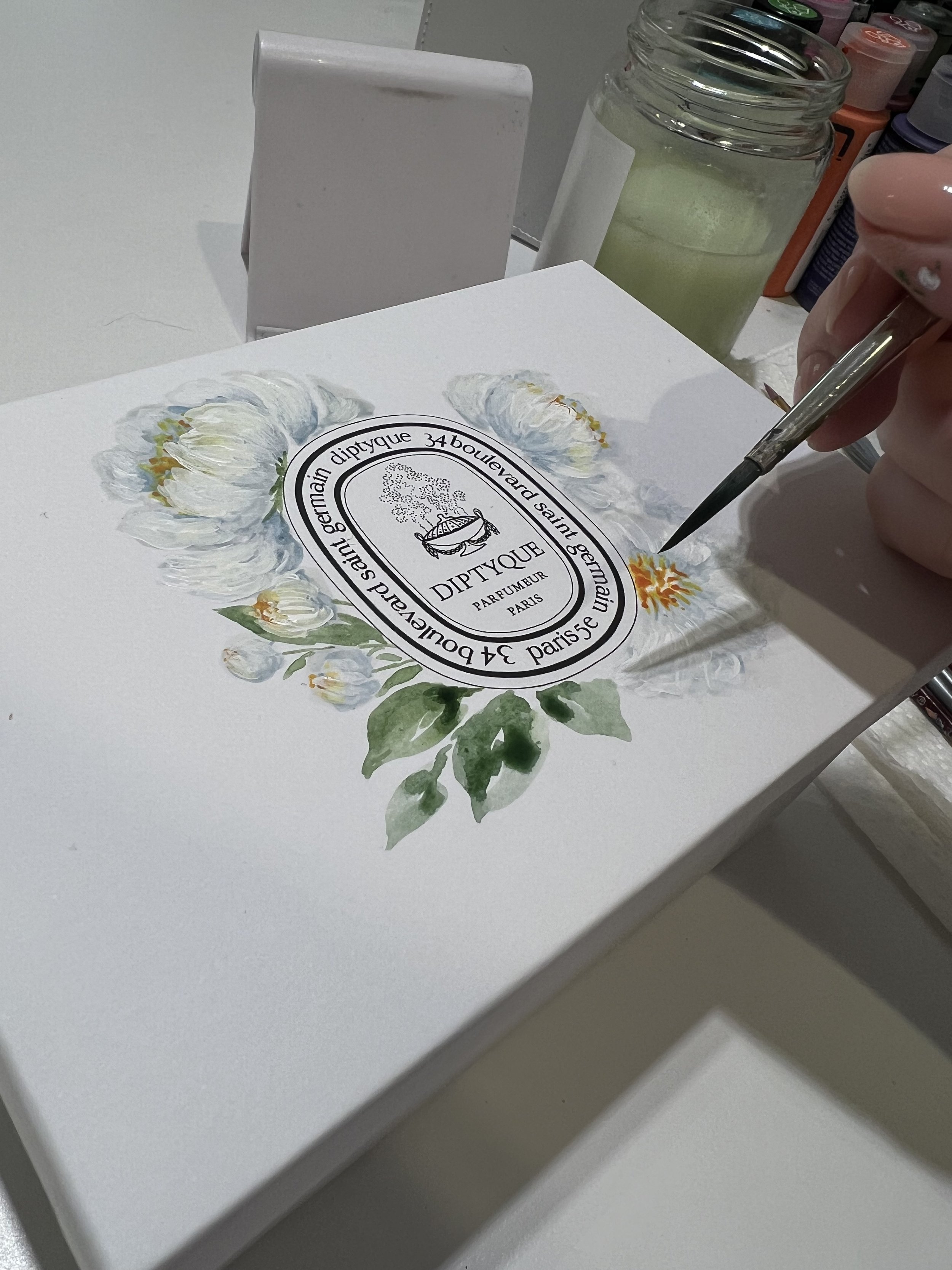 montreal-artist-painting-white-peonies-on-diptyque-candle-boxes.jpeg