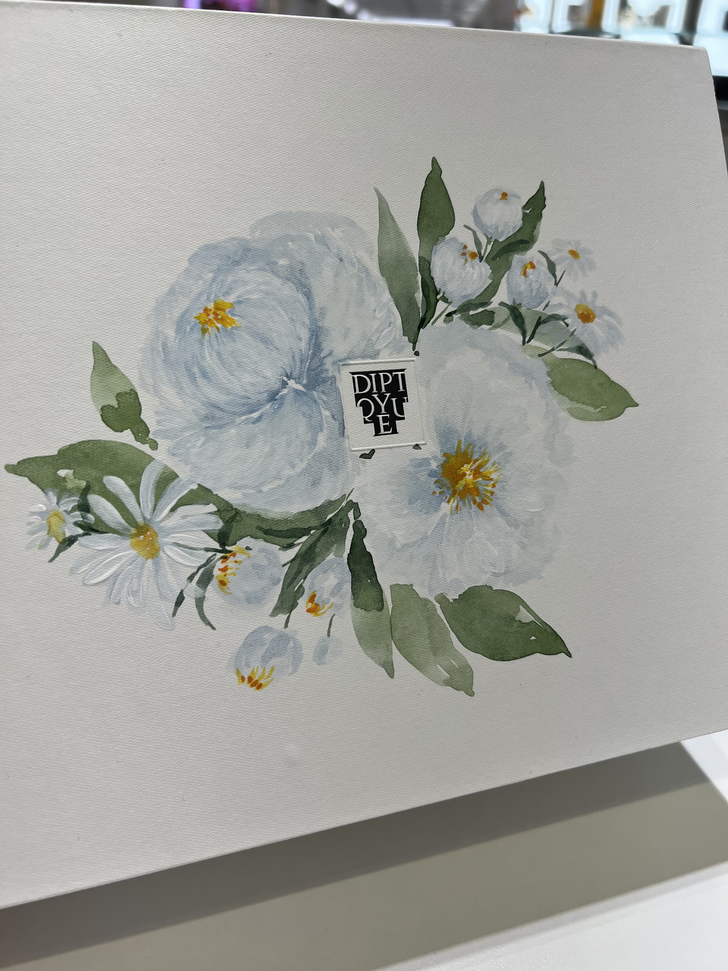 white-flowers-painted-on-diptyque-candle-boxes-montreal.jpeg