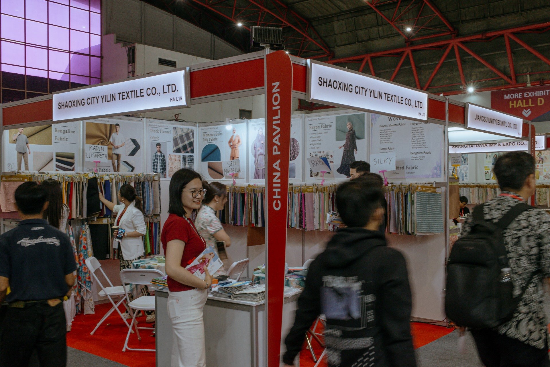 Sales woman (center red) offering their textile product to visitors at a textile and garment industry trade show, Indo Intertex and Inatex, held at the JIExpo Arena, Jakarta, Indonesia (16/4/25). This expo inviting many Chinese manufature textile an