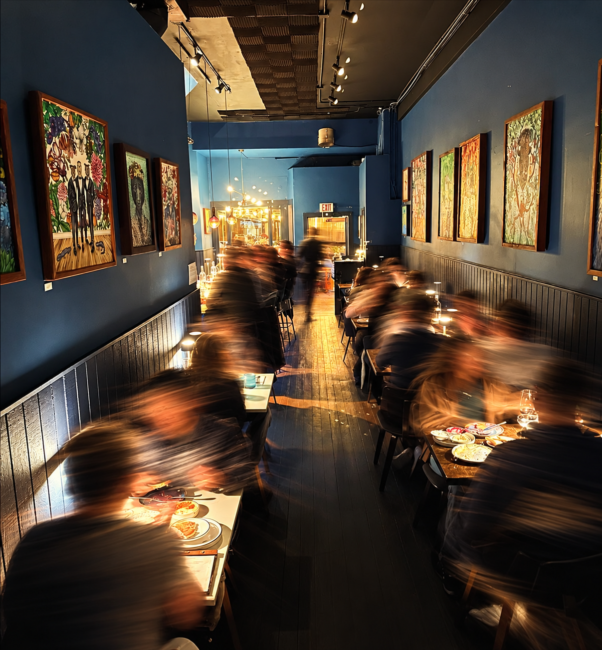 A lively evening in Roaming Goat’s dining room, captured with artistic motion blur.