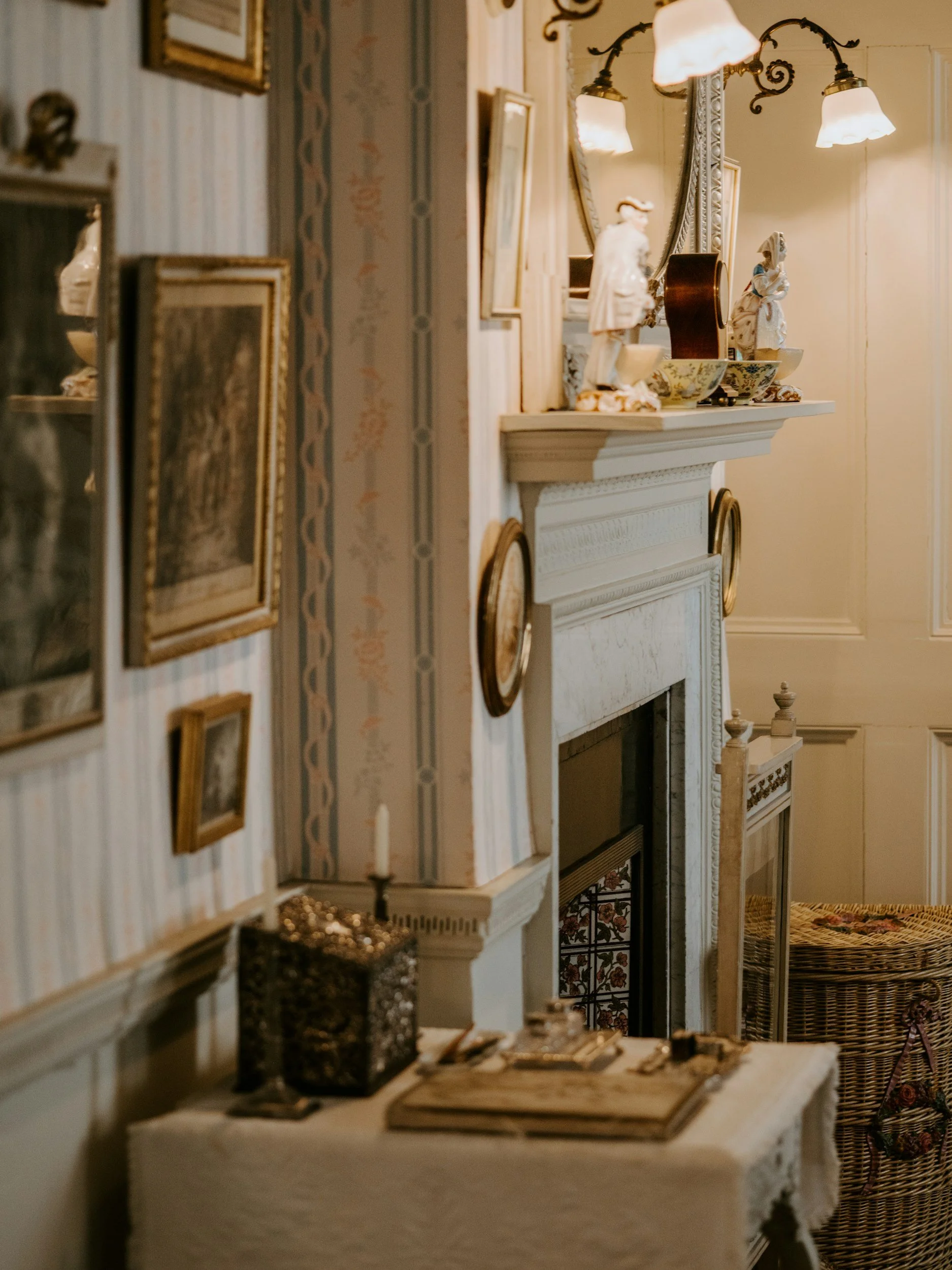 fireplace, frames, wallpaper, books, candles, table, mirror, wicker, rattan, gold