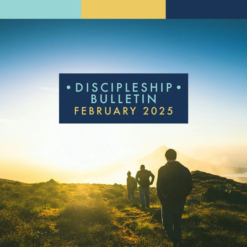 Three people walking over a grassy knoll