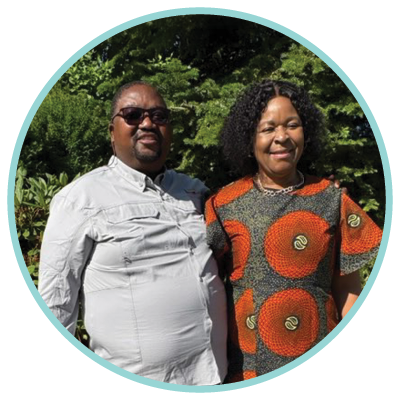 Headshot of a middle-aged man with a bald head, beard, and mustache, wearing a white collared shirt and smiling.