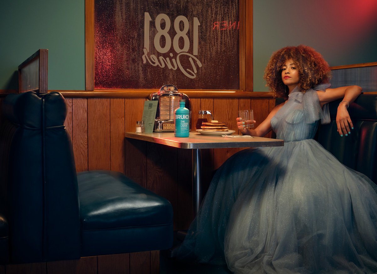 A beautiful lady in a ball gown sipping a cocktail and having some pancakes. Food and beverage styled by David Probasco in Hollywood, California. 