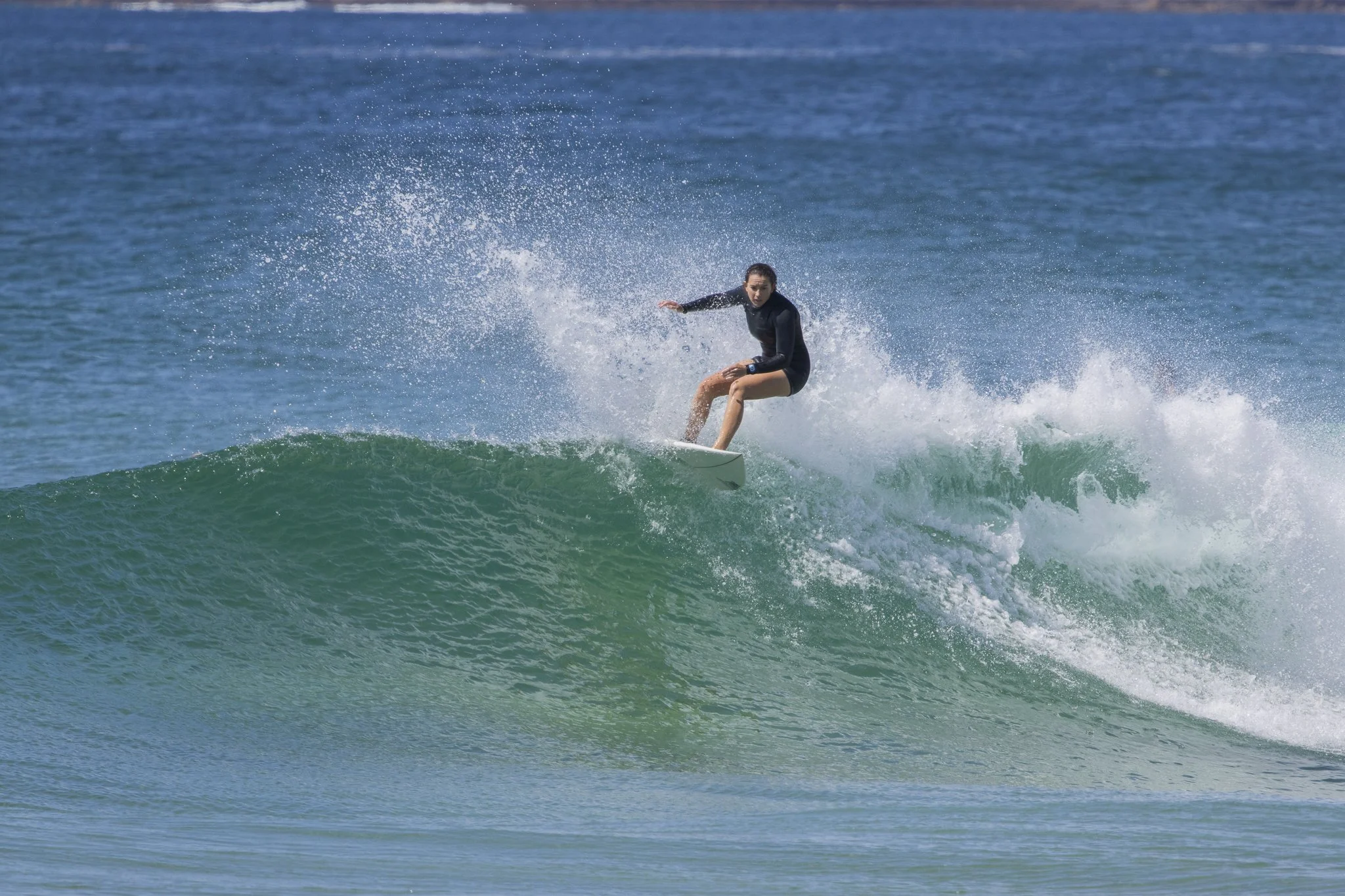 A woman surfing on a wave in the ocean