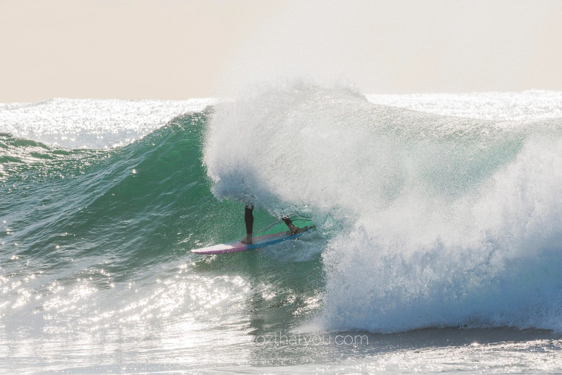 A person surfing on a wave in the ocean