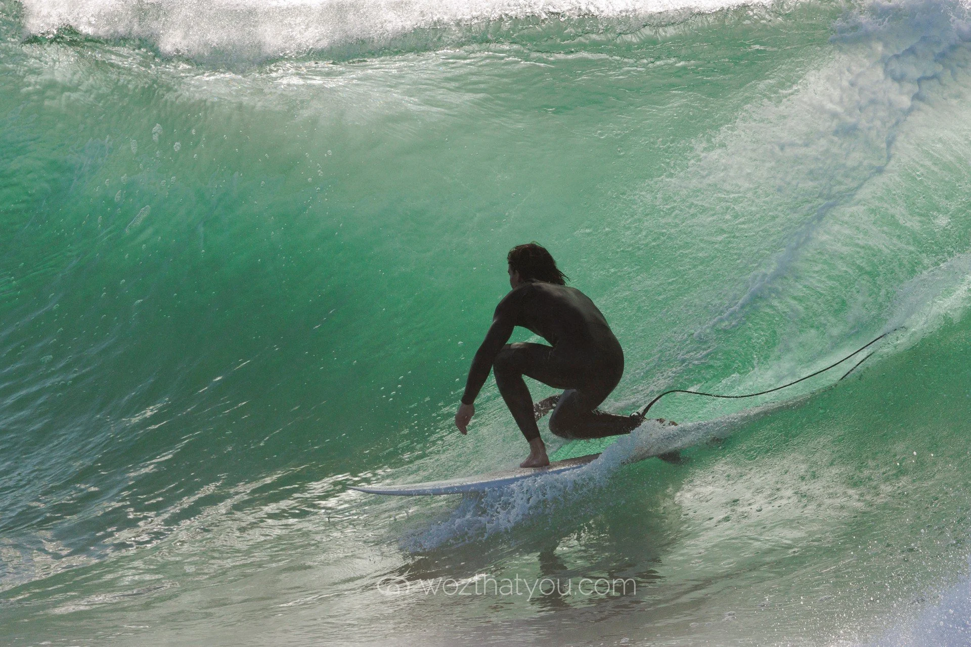 A person surfing on a wave in the ocean.