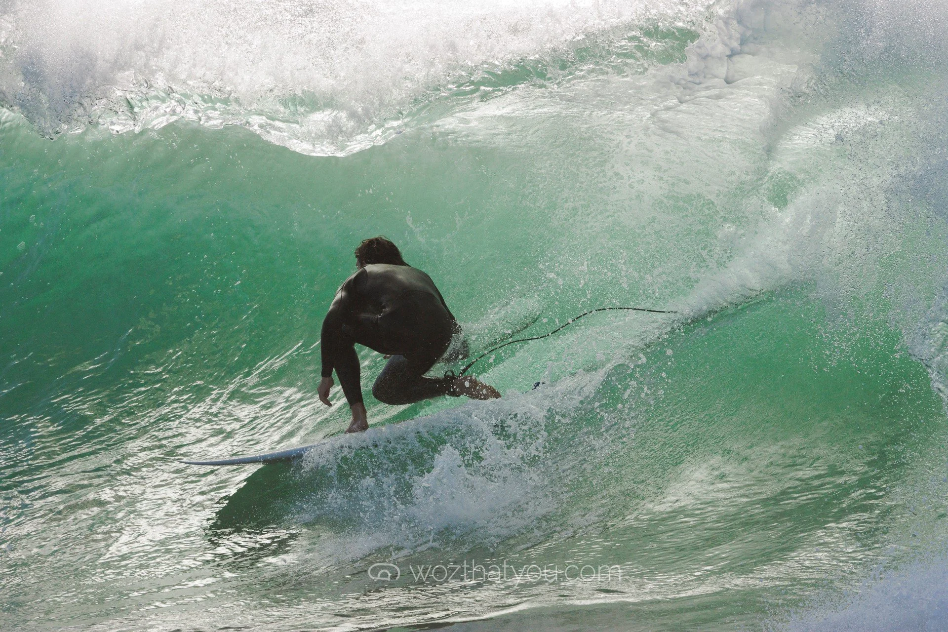 A person surfing on a wave in the ocean.