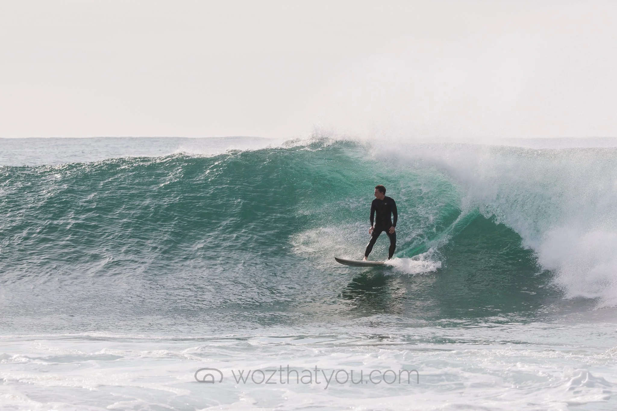A surfer riding a wave in the ocean.