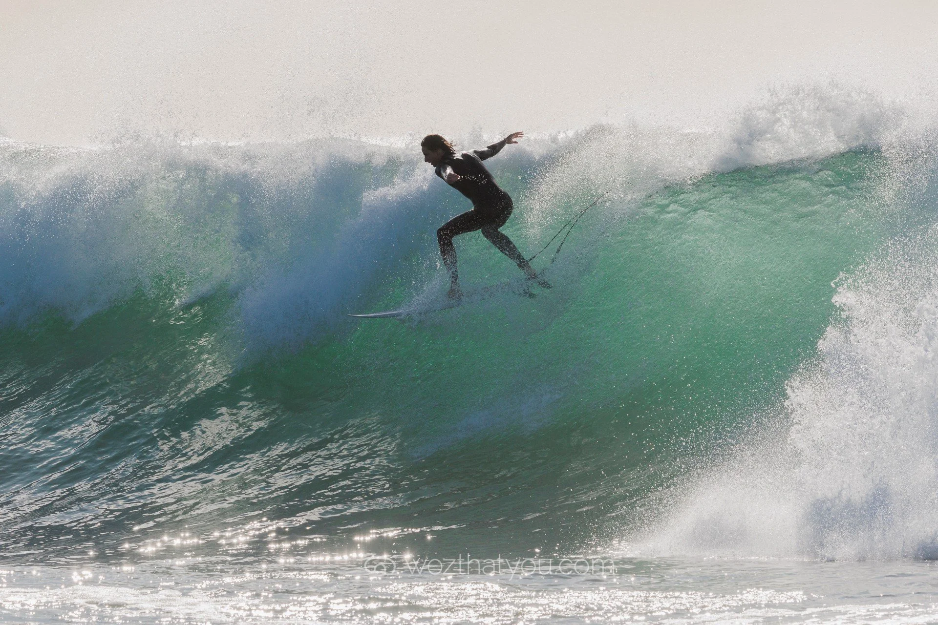 A person surfing on a wave in the ocean.
