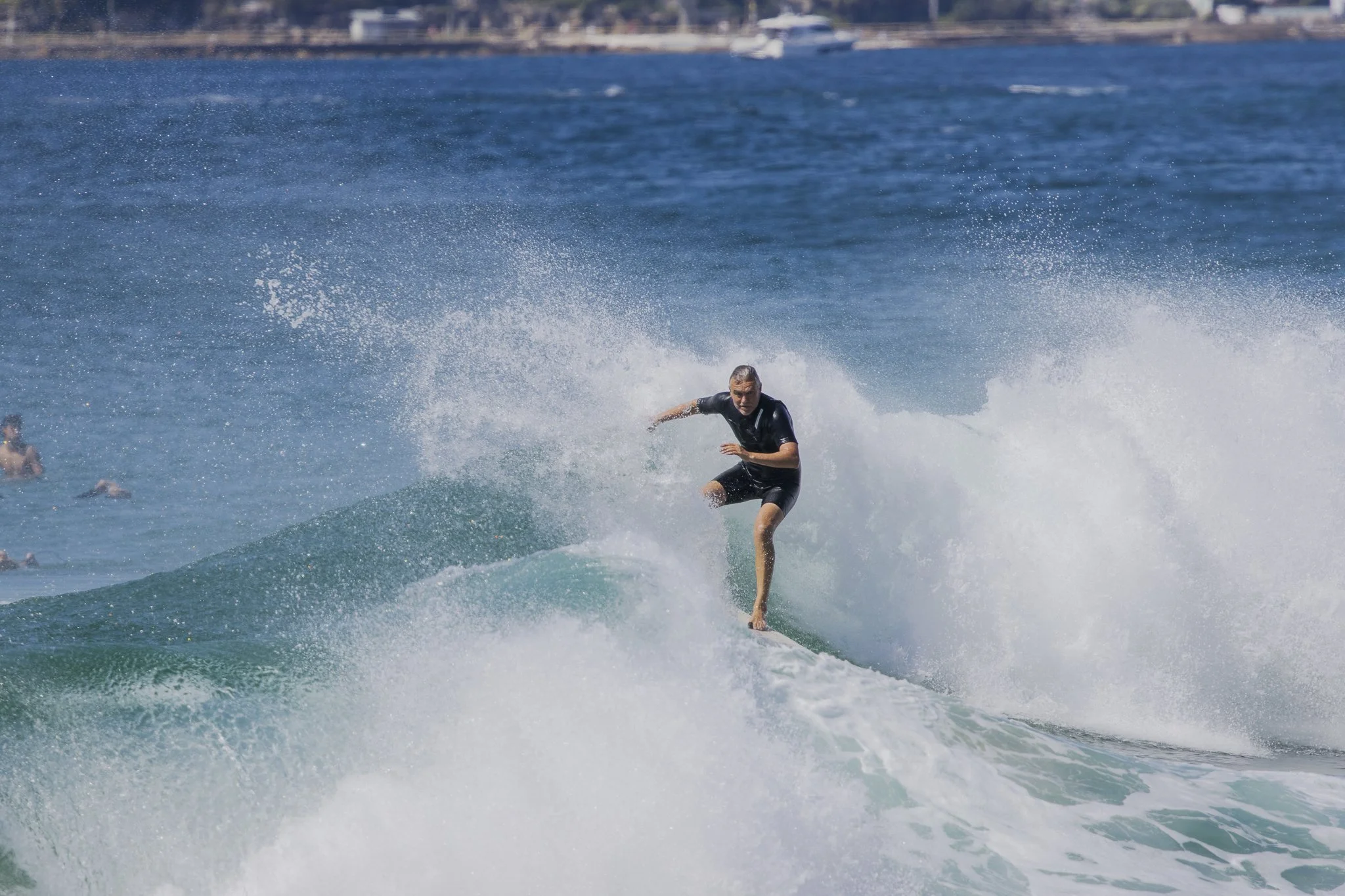 A man surfing on a wave in the ocean.