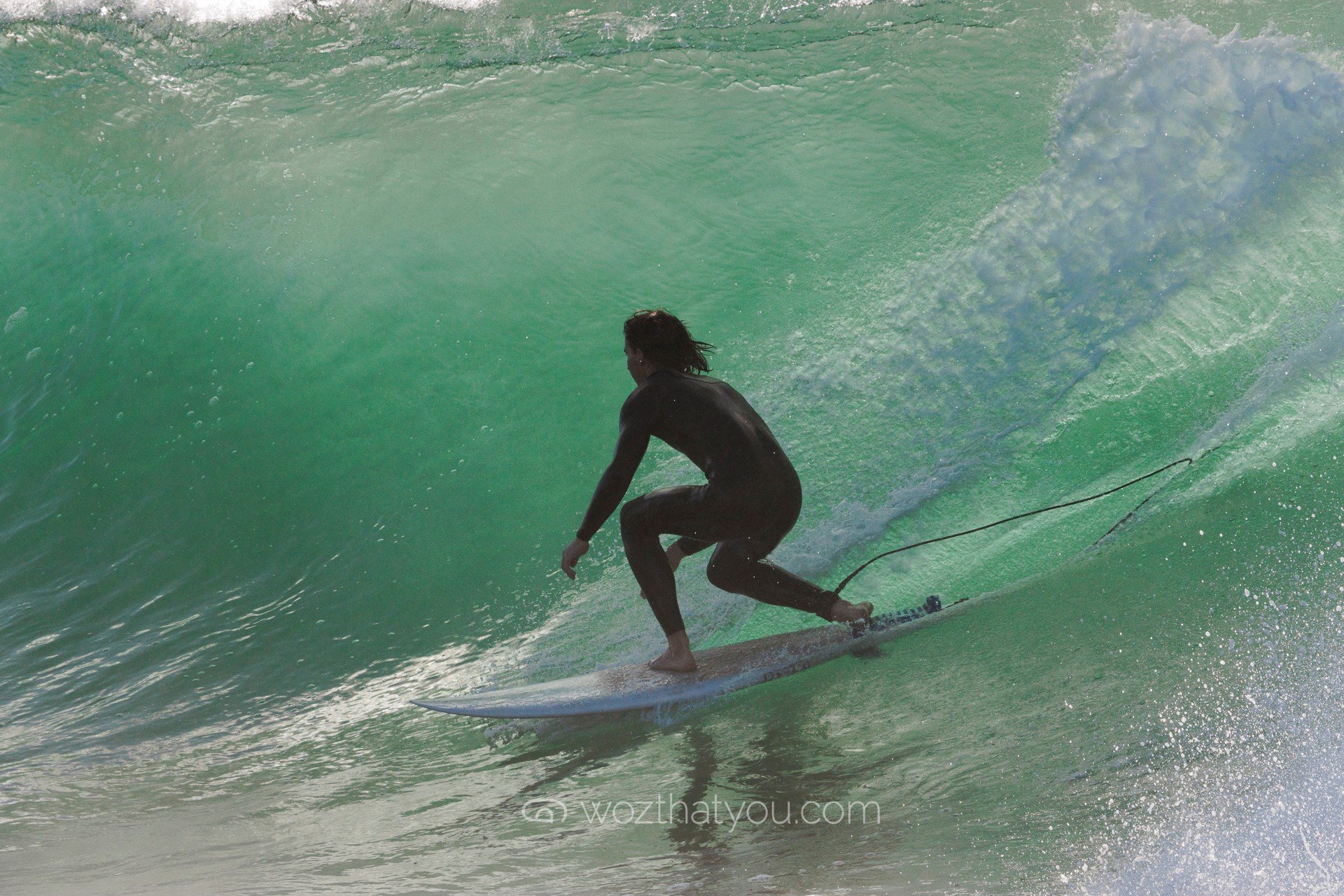 A person surfing on a wave in the ocean.