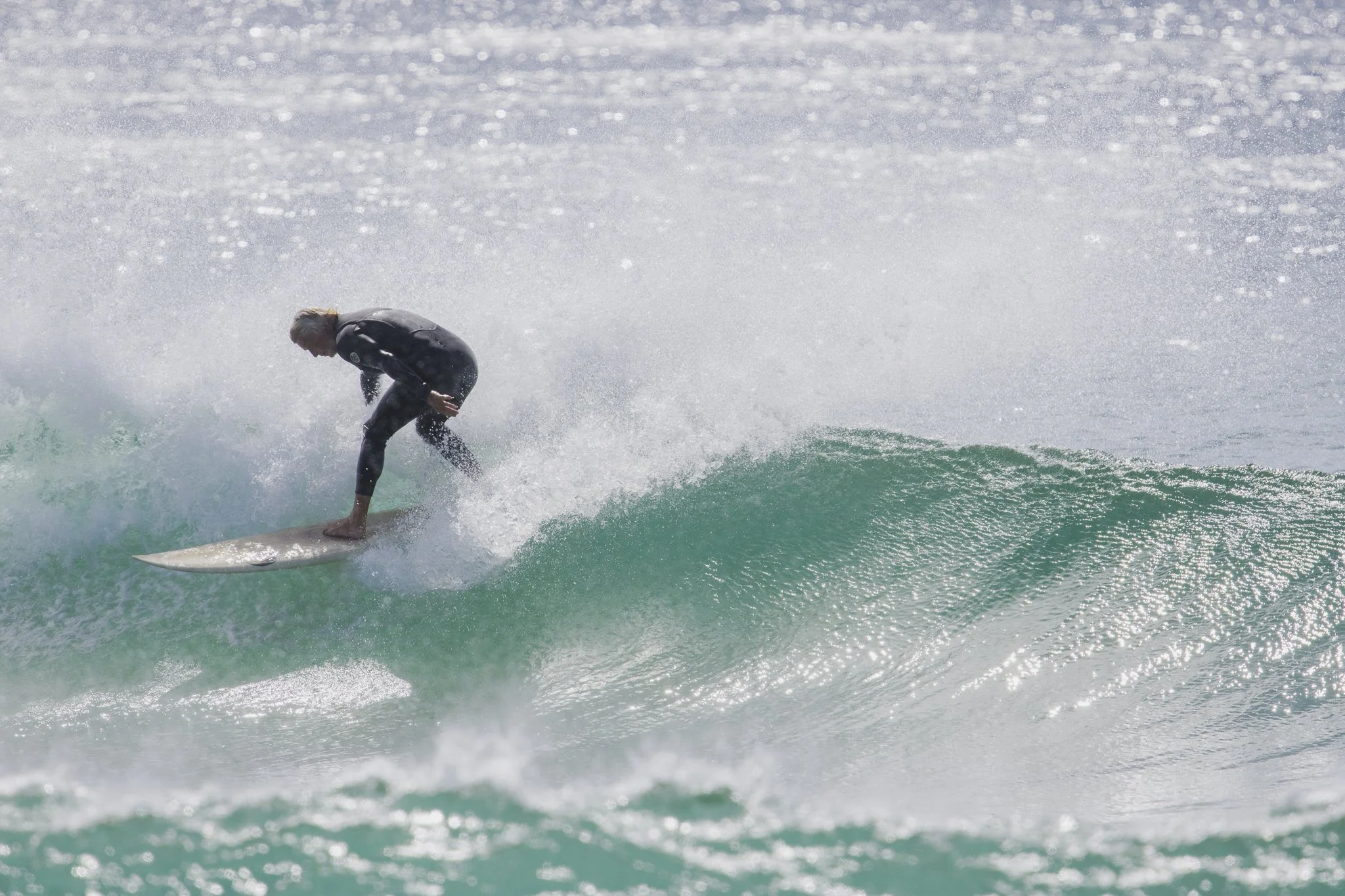 Surfer riding a wave in the ocean during daytime