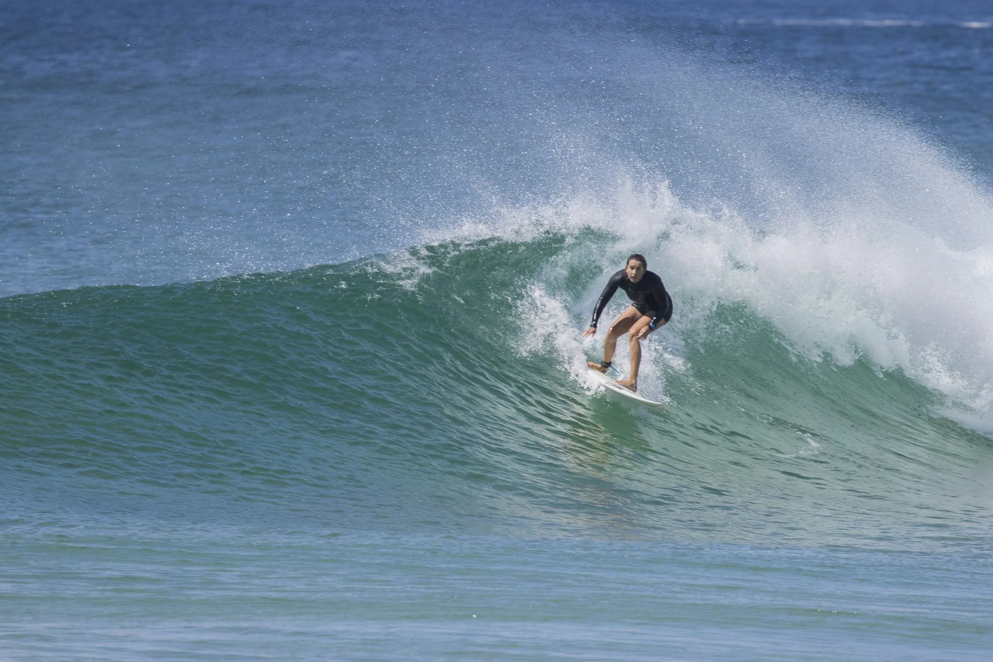 A person surfing on a wave in the ocean.