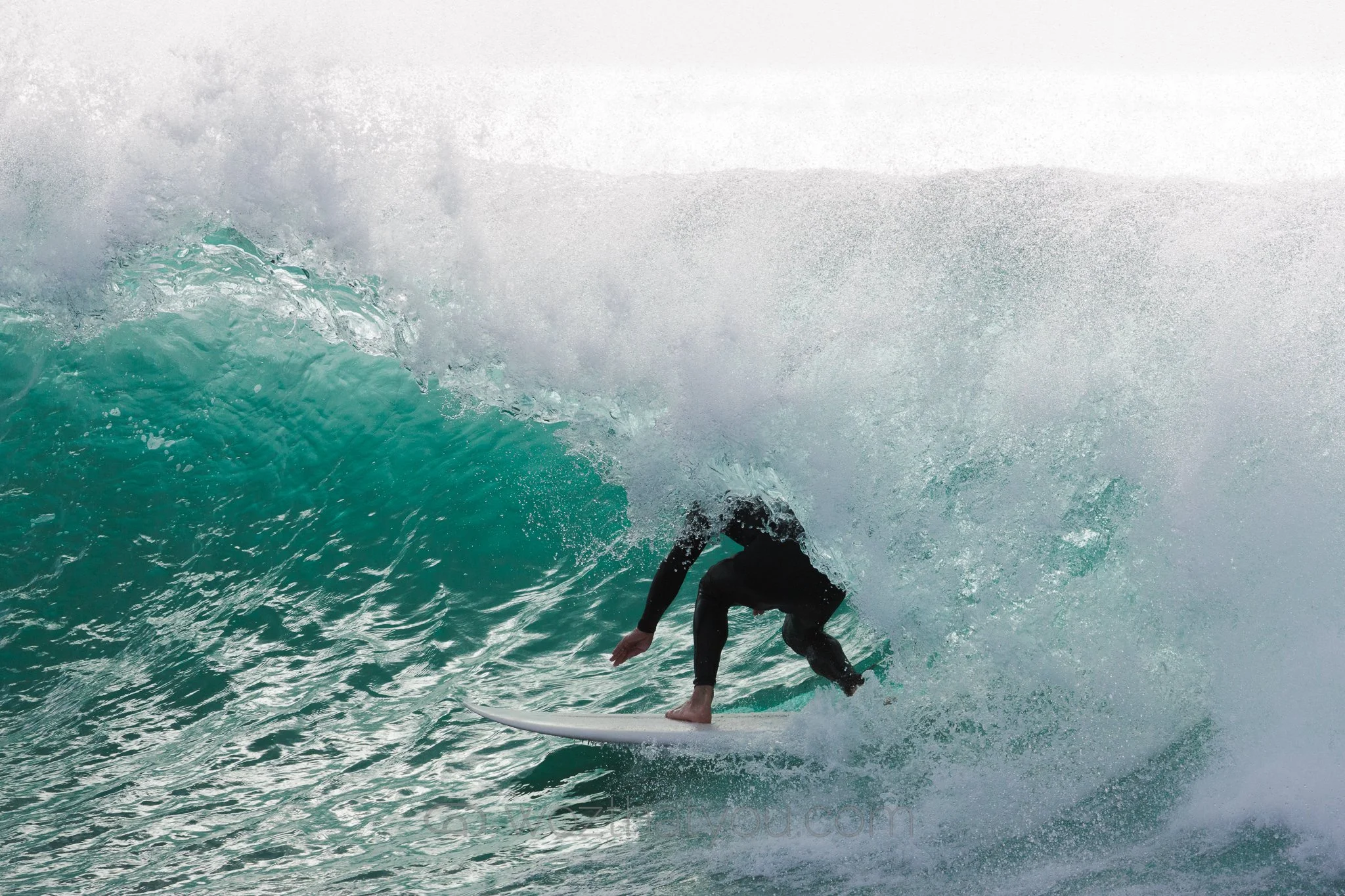 Surfer riding inside a wave in the ocean.