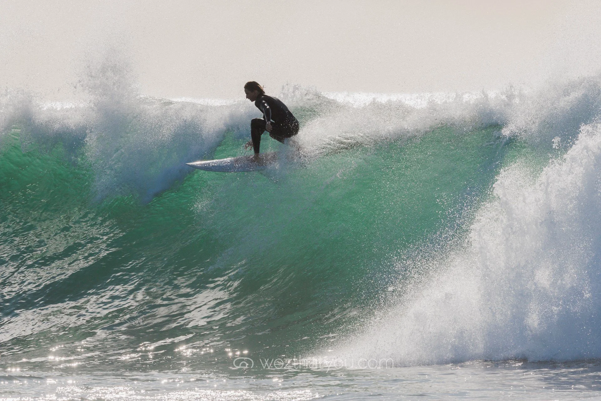 A person surfing on a wave outdoors.