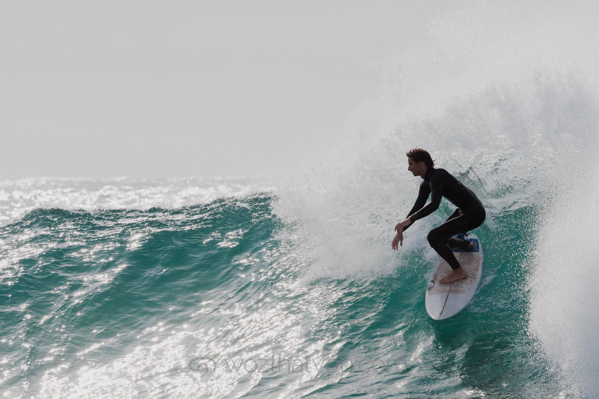 A person surfing on a wave in the ocean.