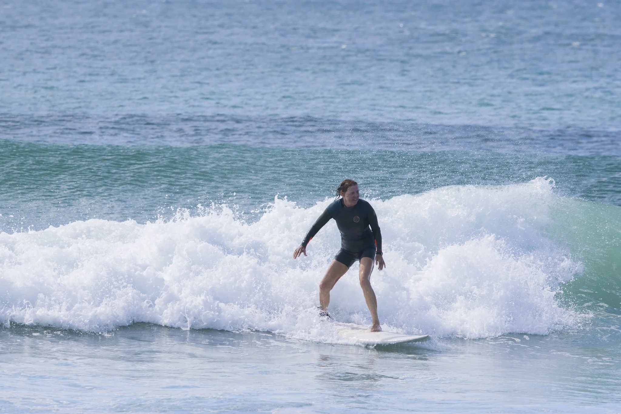 Woman surfing on a wave in the ocean