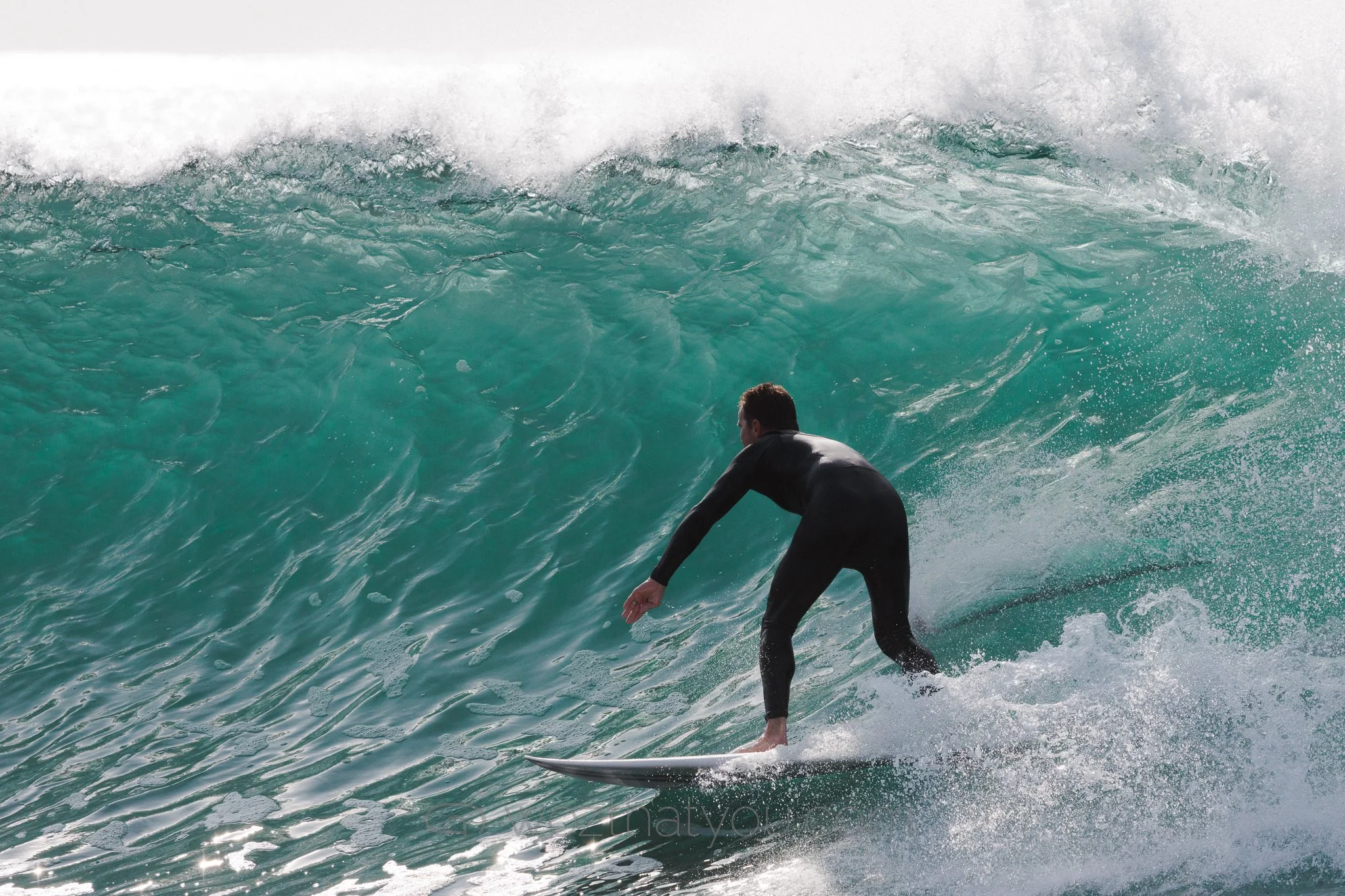 Surfer riding a wave in the ocean.