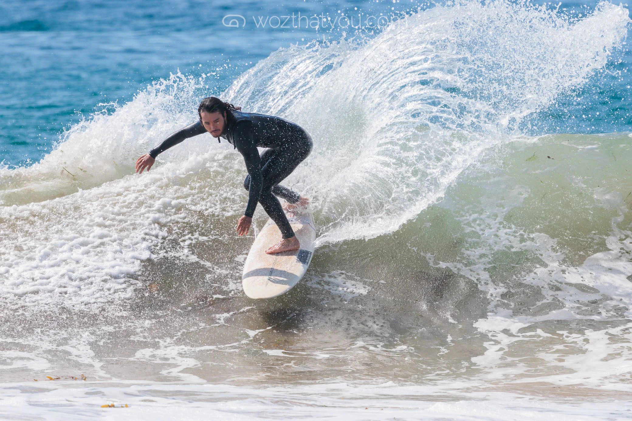 Man surfing on a wave at the beach