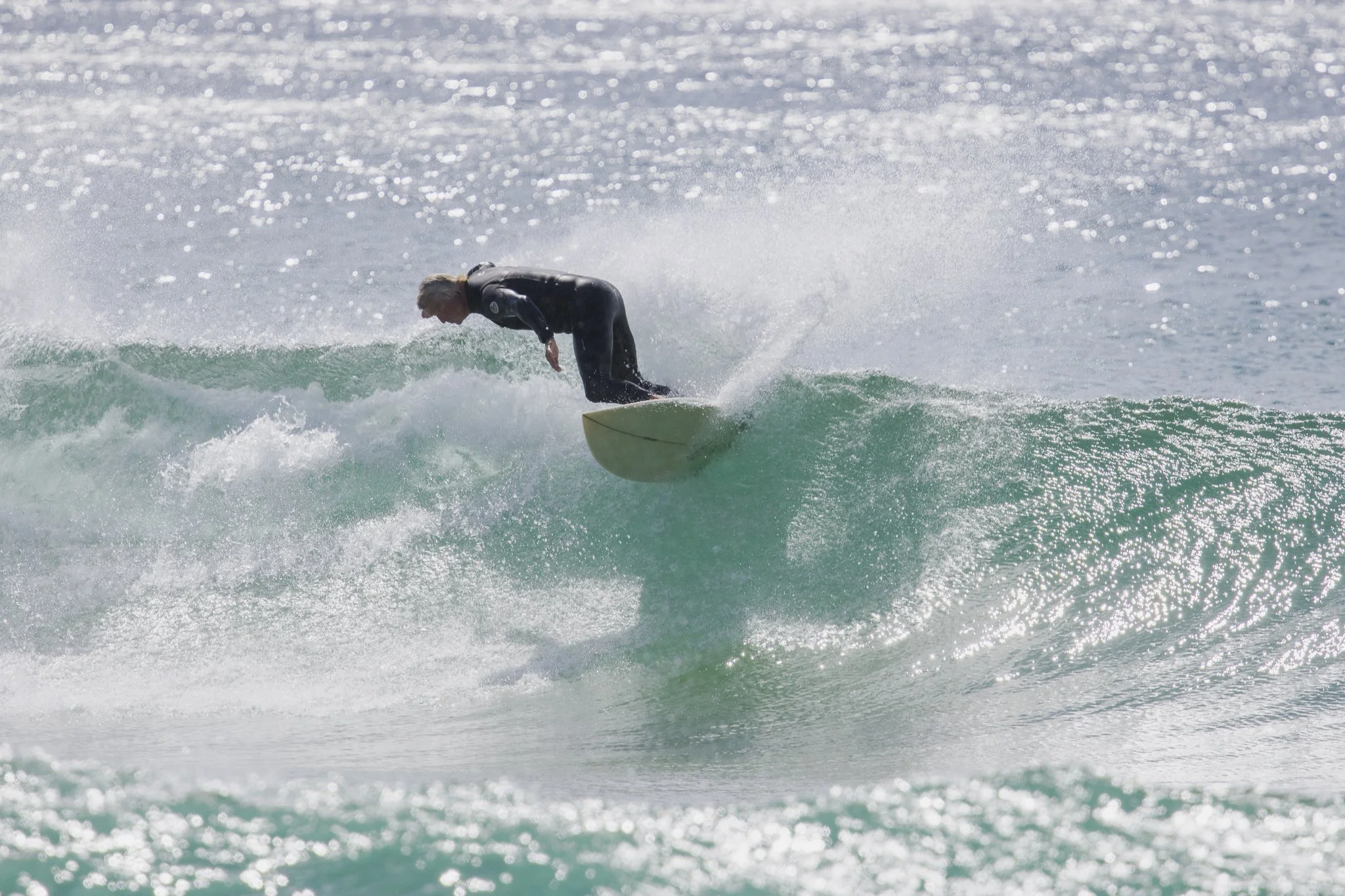 Surfer riding a wave in the ocean.