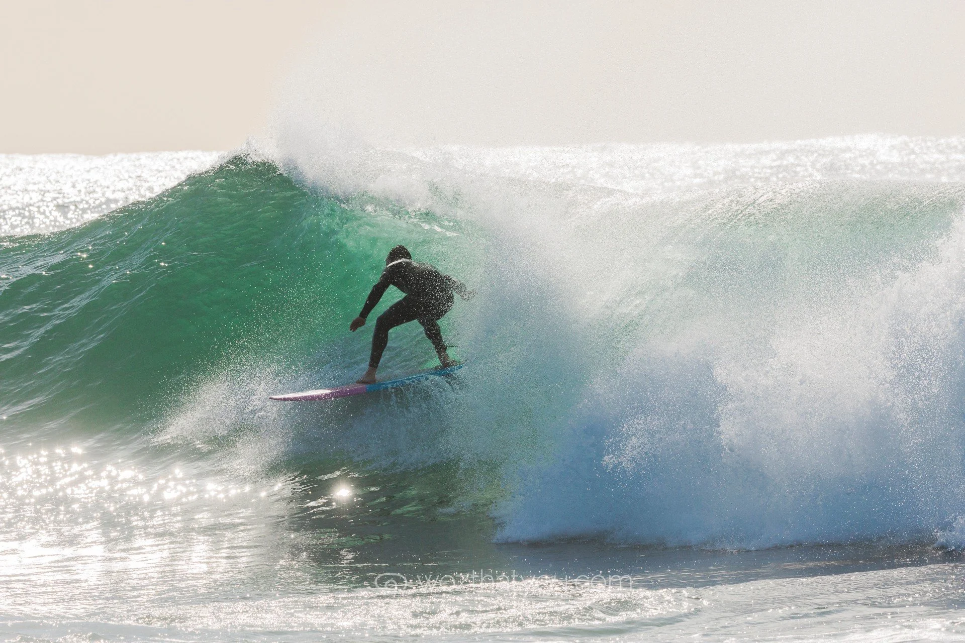 A person surfing on a wave in the ocean.
